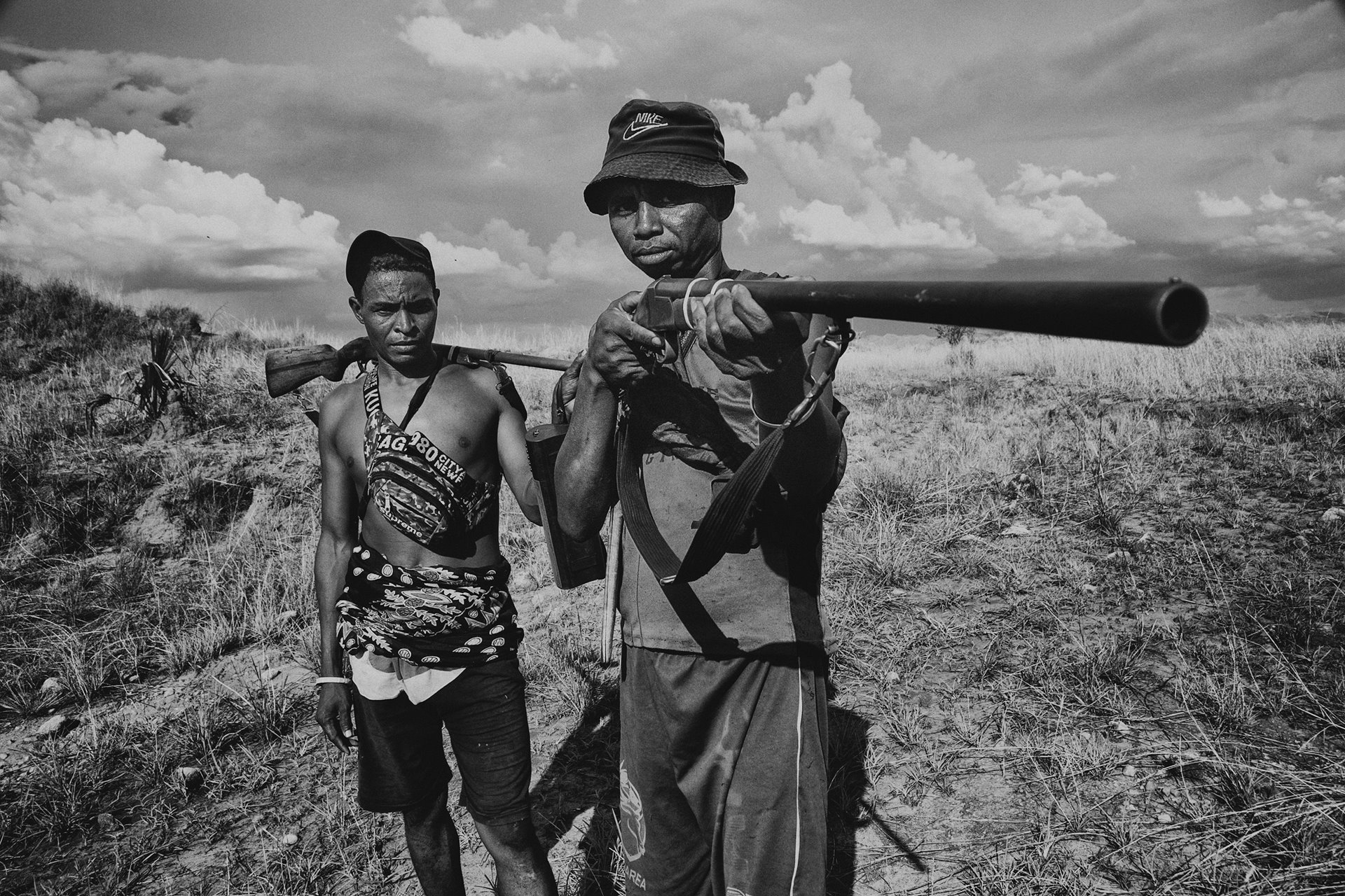 Lemana (left) and Lemena (right) pose with their guns. They live in the village of Marotahalaky, in Menabe, Madagascar. The village is the base of Mahasoaky, the man said by military authorities in the region to be the mastermind of numerous large zebu theft operations.