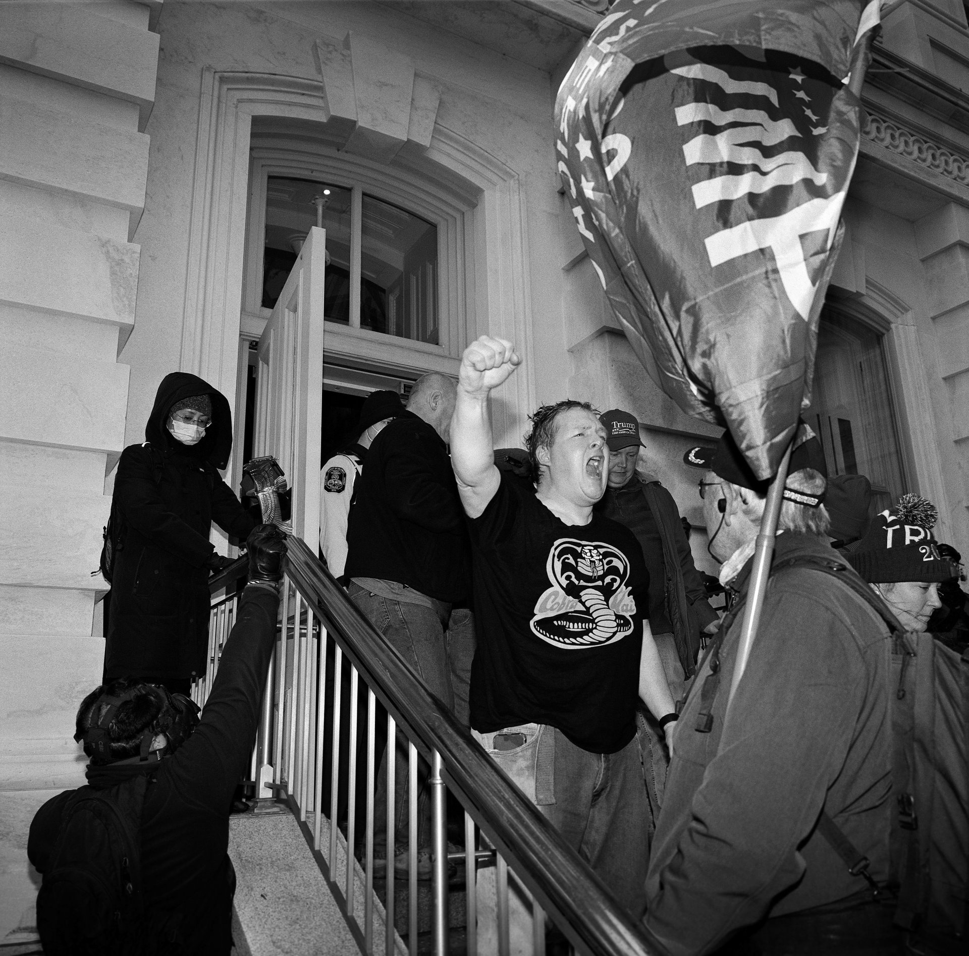 A Trump supporter pumps his fist as he is ejected from the Capitol Building, after it had been breached by rioters in an attempt to stop the certification of the 2020 presidential election, Washington DC, USA.