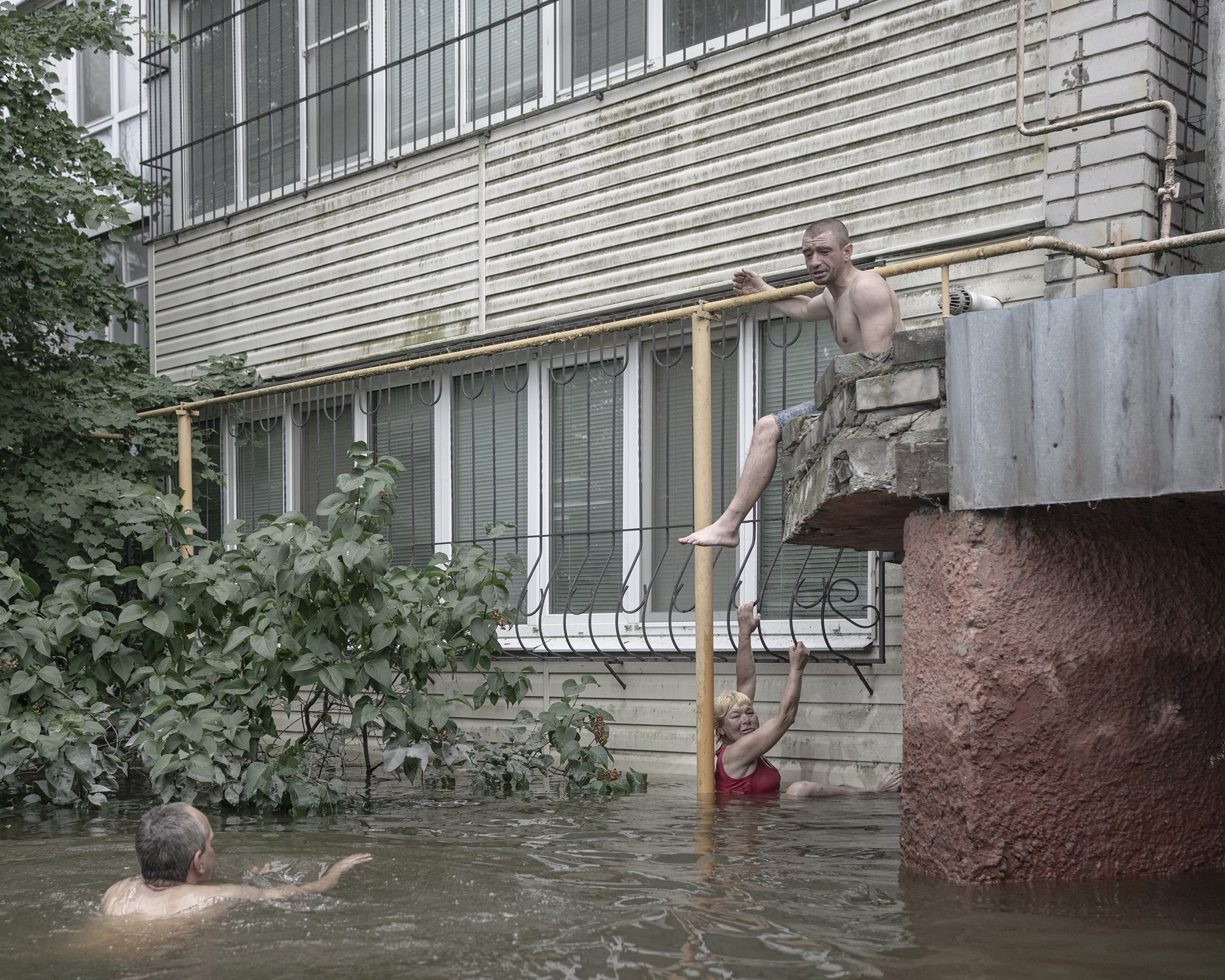 Three friends attempt to swim between their houses in Kherson, Ukraine.