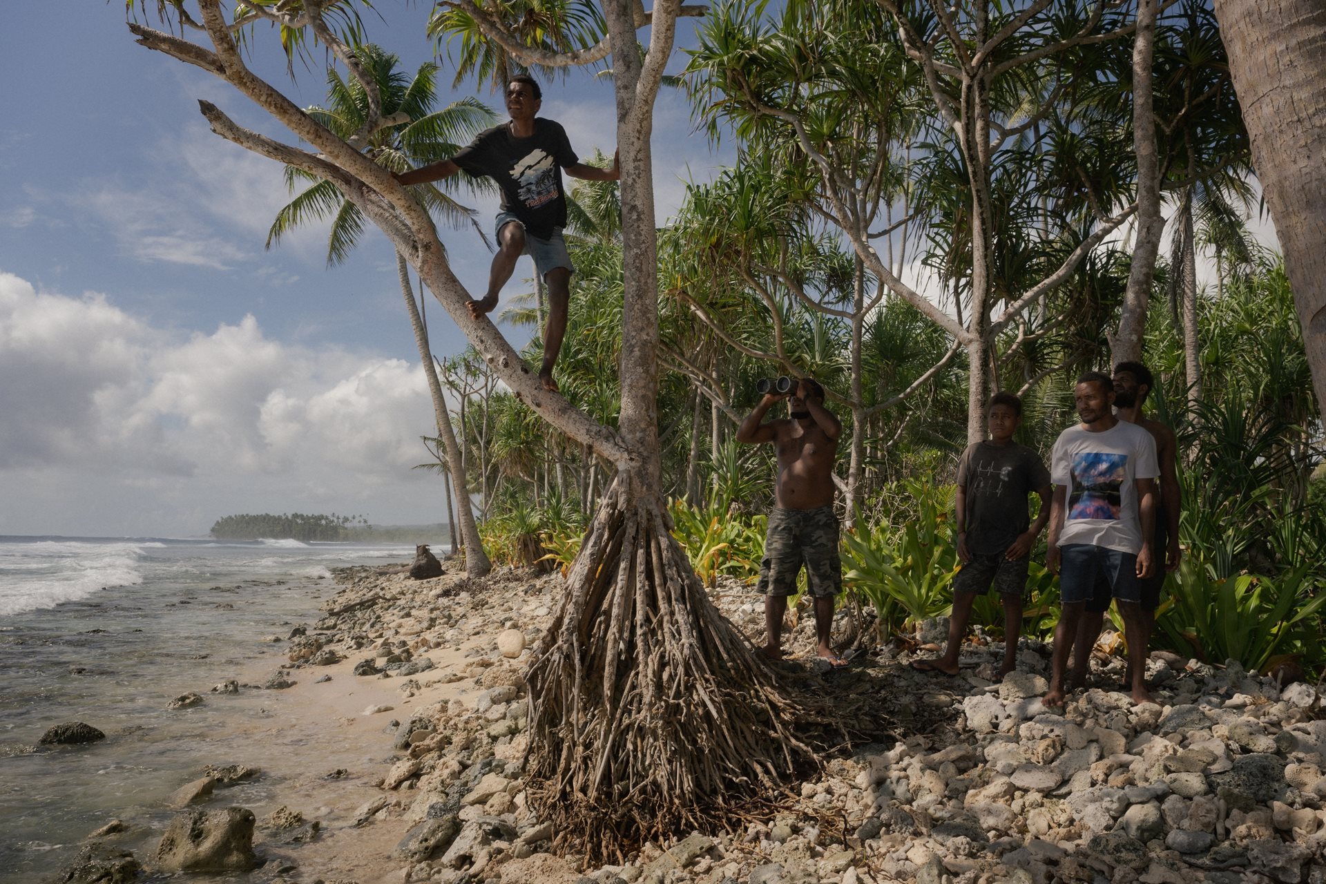 Young men scan the Surodo Lagoon for signs of a successful hunt. During the 2025 season, unpredictable weather and rougher seas resulted in repeated failed attempts for the Fanalei dolphin hunters. Fanalei Island, South Malaita, Solomon Islands.&nbsp;