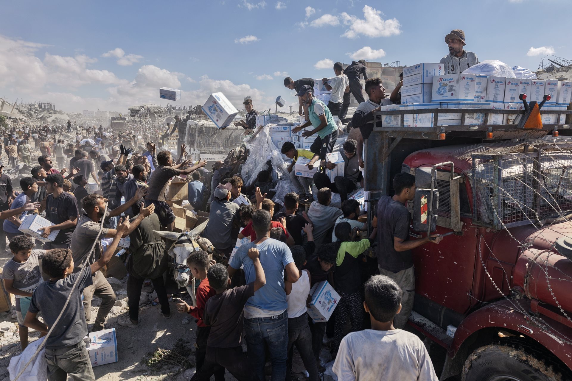 Hundreds of Palestinians run toward a convoy of aid trucks in Khan Younis, Gaza Strip, that had just entered the territory.