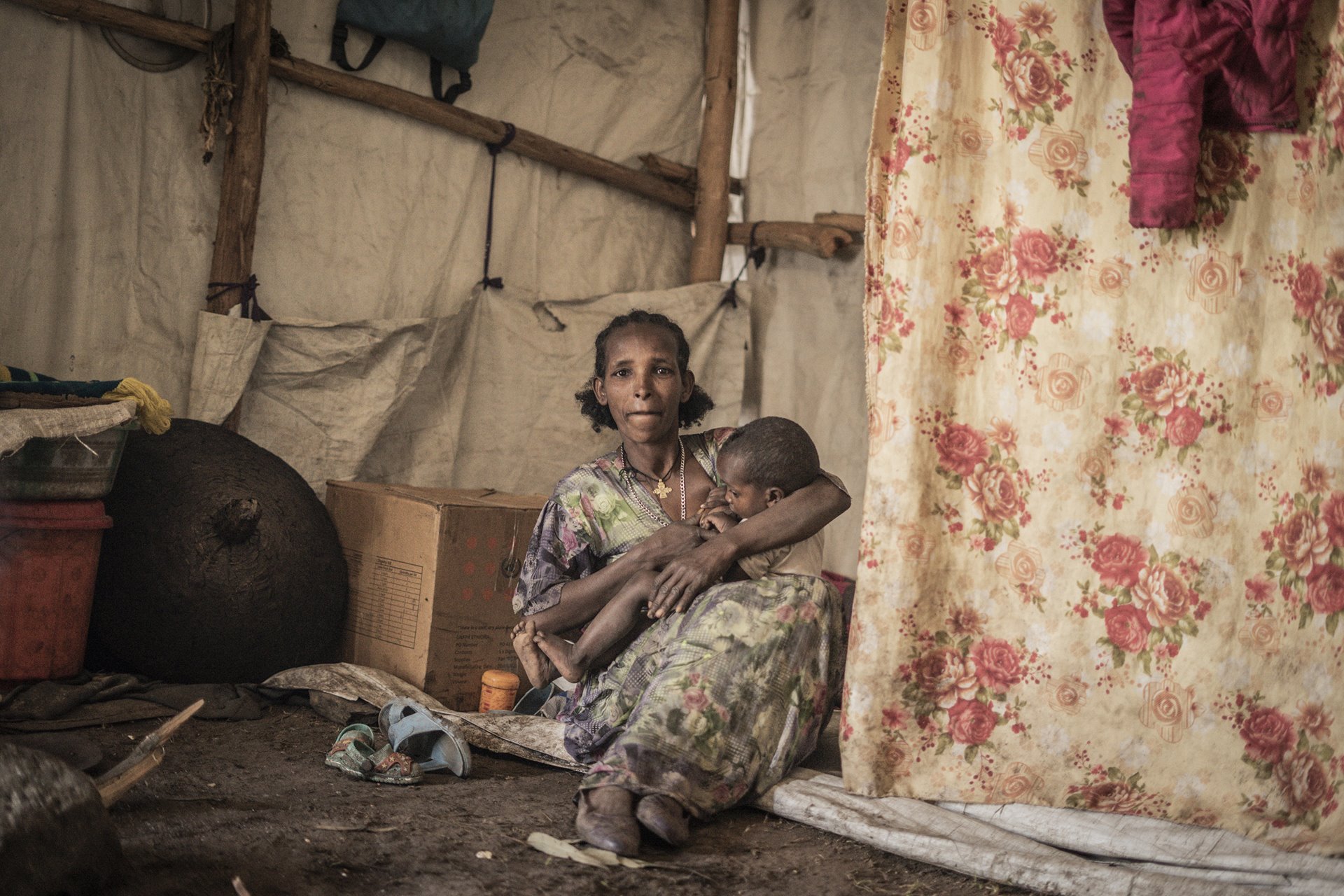 A woman who fled fighting in May Tsemri, in southern Tigray, poses for a photograph as she takes shelter in a temporarily built camp in Dabat, 70 kilometers northeast of the city of Gondar, in Amhara, Ethiopia.