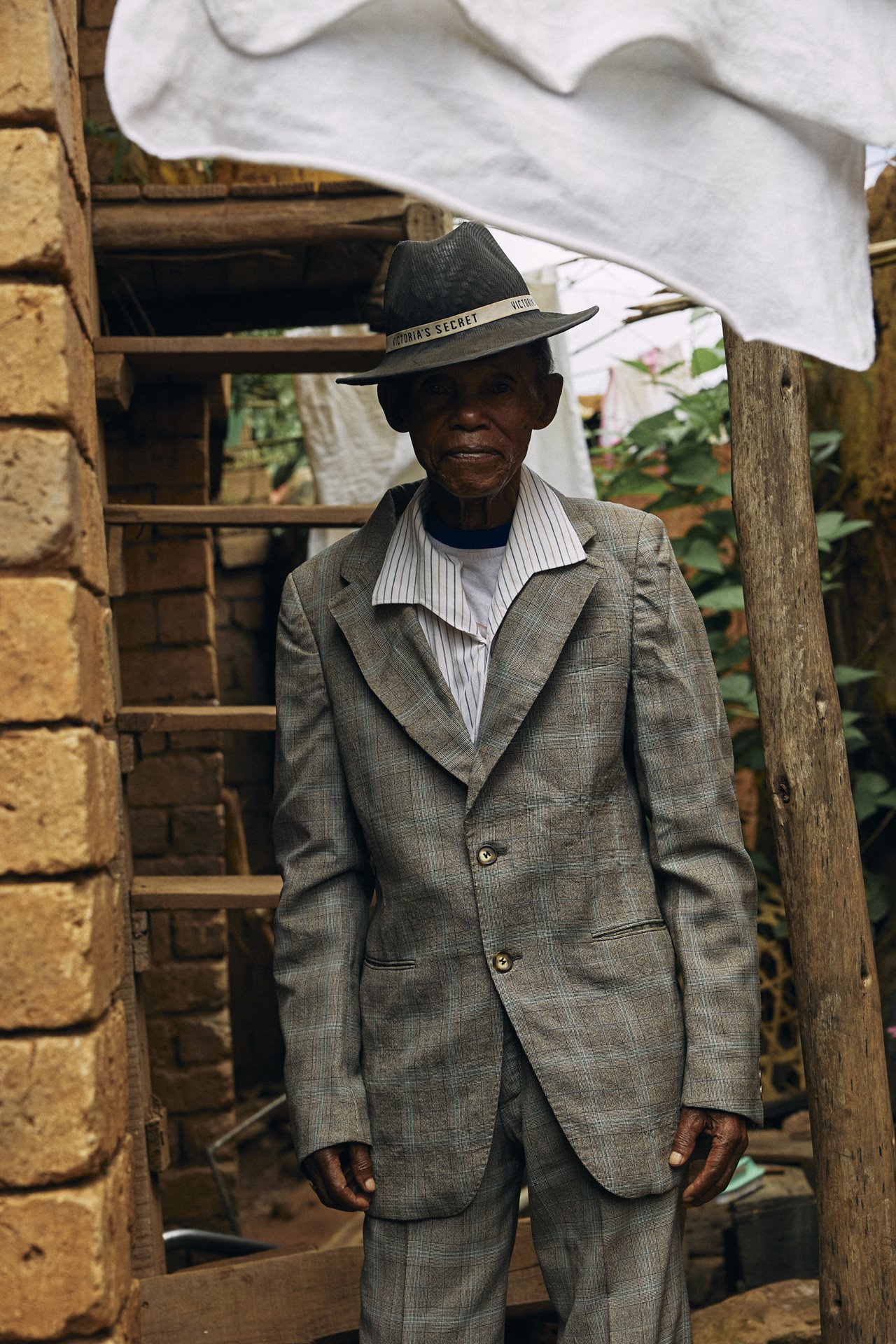 Dada Paul stands in front of the house where he grew up, in Antananarivo, Madagascar, after attending church on Sunday morning. He likes to visit his childhood home and reminisce about the past, and insists on stopping there after church almost every Sunday.&nbsp;