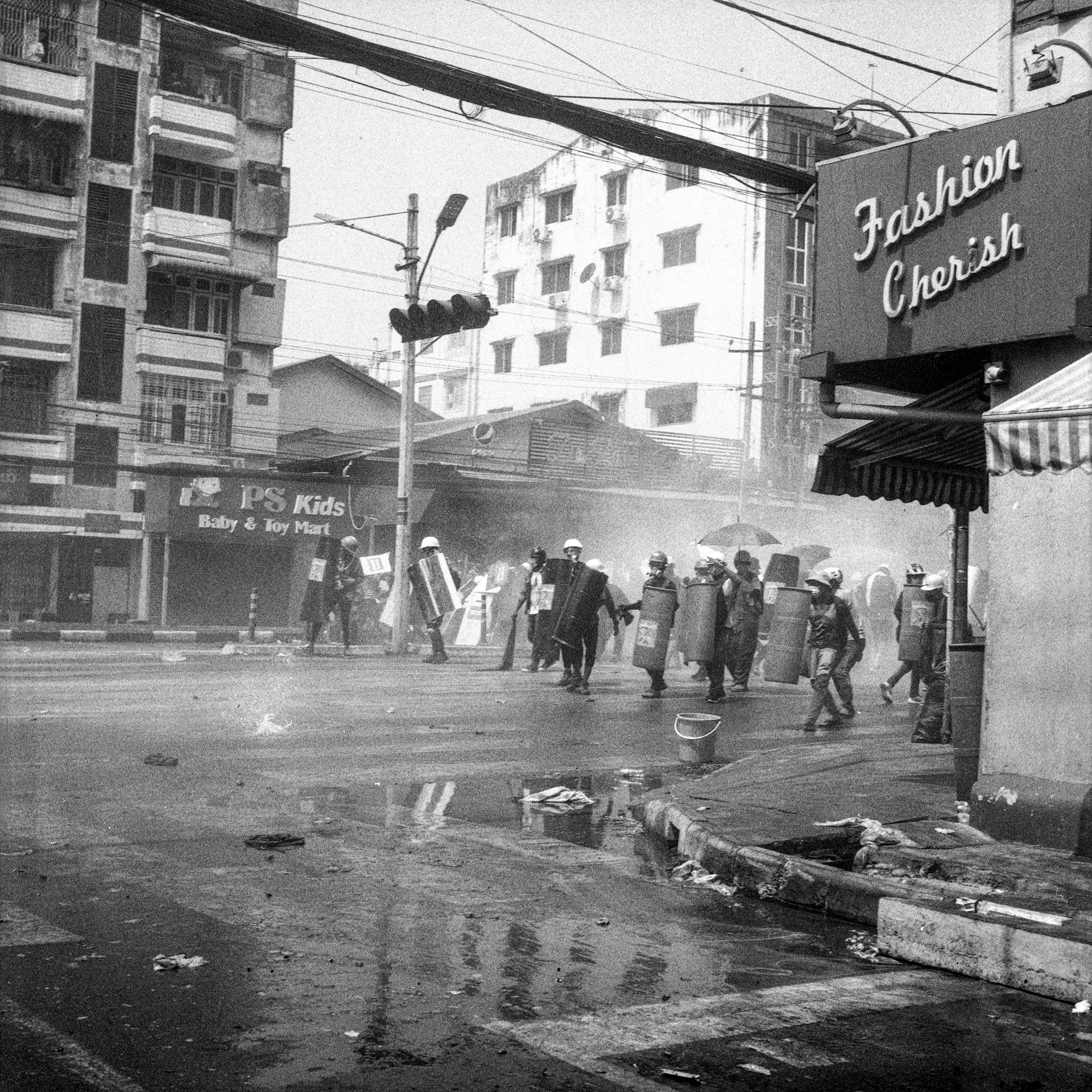 Police​ launch tear-gas grenades durin​g a crackdown on an anti-coup ral​ly in Yangon, Myanmar.