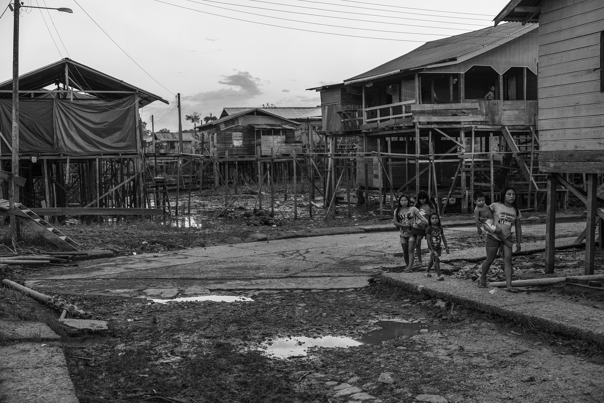 Women walk with their children down a street in Atalaia do Norte, a town in Vale do Javari, a region in the Brazilian Amazon with a large number of different Indigenous communities, including isolated and uncontacted groups. The town is a focus point for health, education, and supply services in the region, and is frequented by people who live in the Vale do Javari Indigenous Land. It also has a large number of churches and missions. Evangelical groups target Indigenous communities, and Indigenous people&rsquo;s organizations have raised concerns that this violates their right to maintain their cultural heritage and sacred practices, and also threatens their safety. Missionary groups have been accused of spreading diseases among previously uncontacted groups, and of provoking social conflict by telling communities that their dances and beliefs are evil.