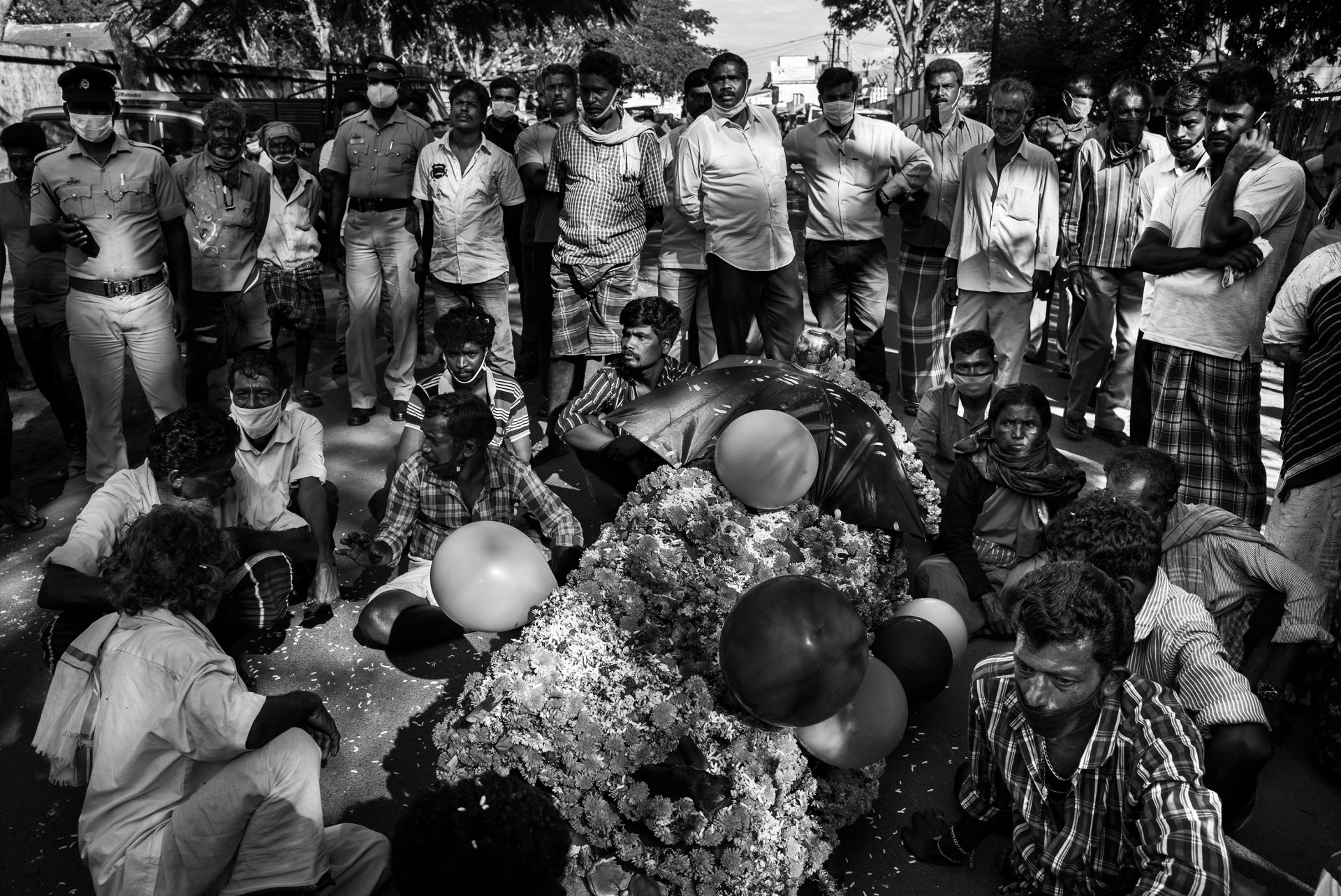 Residents of a village near the Mudumalai Tiger Reserve, in Tamil Nadu, India, place the body of a man killed by a tiger before the forest office, to protest and demand that officials shoot the tiger.