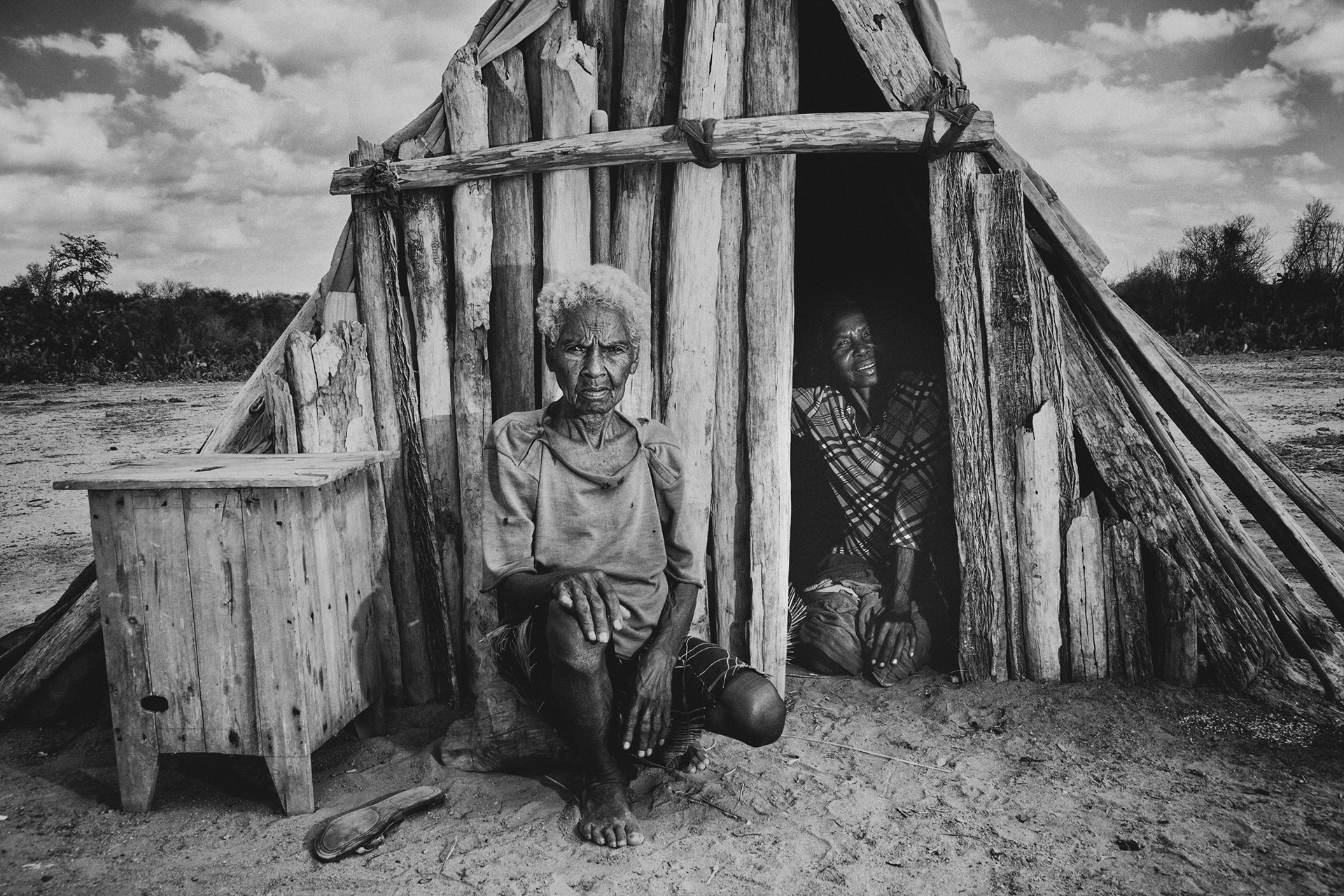 Ms Behora (left) and her daughter Ndakope are portrayed at their home in Ifotaka, southern Madagascar. Behora says they receive no aid, and do not get enough to eat. Southern Madagascar is gripped by a severe food crisis, following decades of drought.