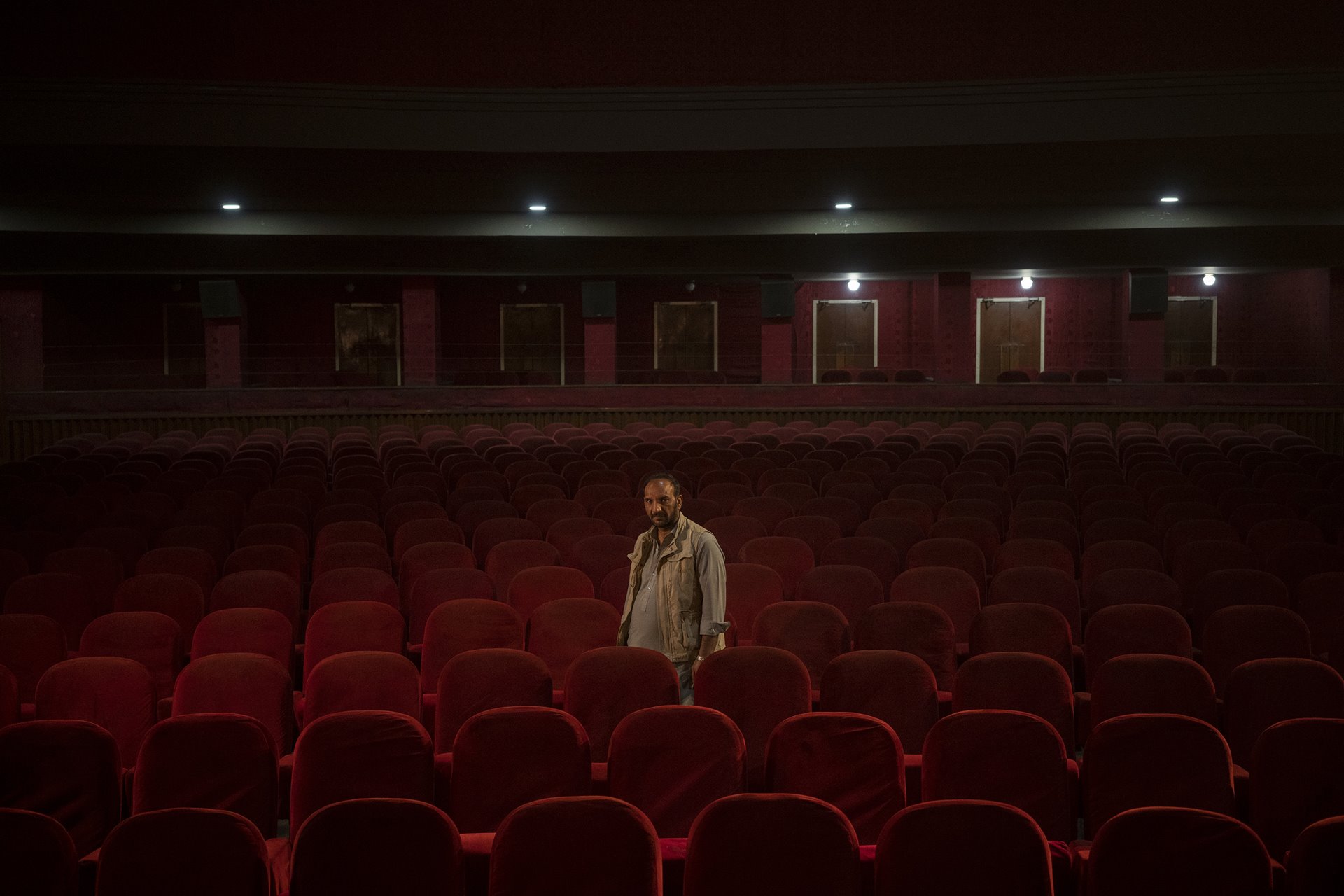 <p>Gul Mohammed, who works as an usher in the Ariana Cinema in Kabul, Afghanistan, poses for a photograph nearly three months after the Taliban closed the cinema.</p>
