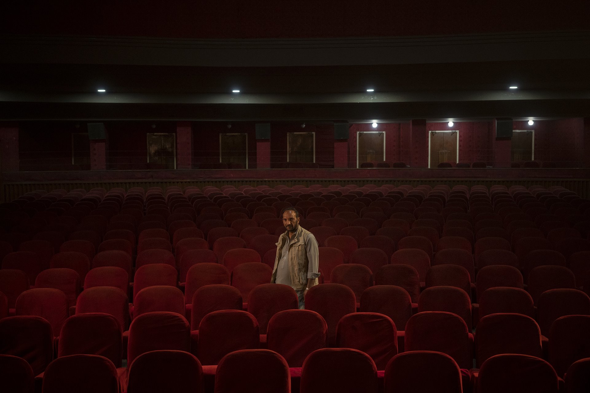 <p>Gul Mohammed, who works as an usher in the Ariana Cinema in Kabul, Afghanistan, poses for a photograph nearly three months after the Taliban closed the cinema.</p>
