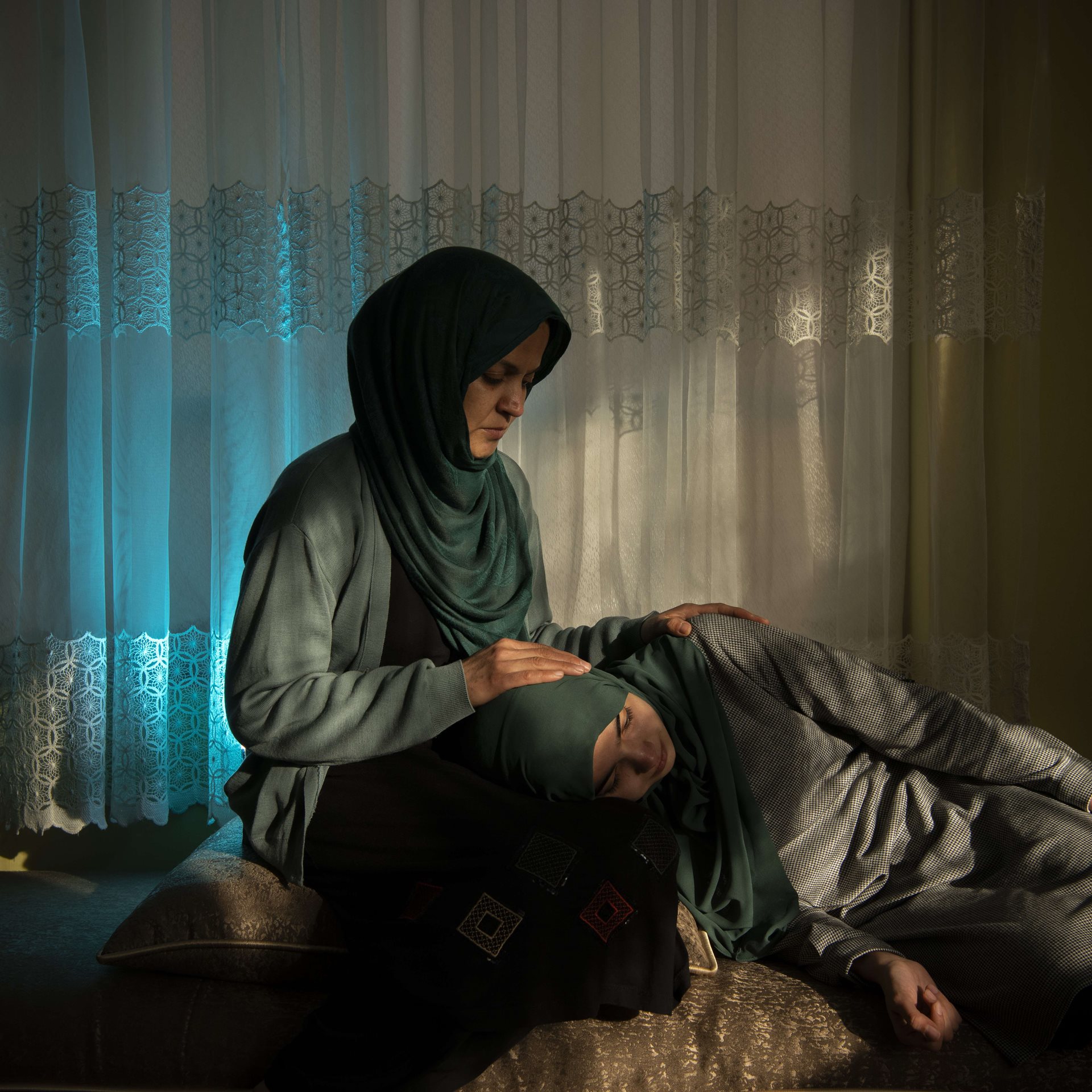Wazhmah sits at home with her daughter Tahmeena (19), in Kabul, Afghanistan. Wazhmah&rsquo;s own education was halted during Taliban control in the 1990s, and she now sees history repeating itself. Like her mother, Tahmeena had just been admitted to university, when a new Taliban regime again closed higher education to women.