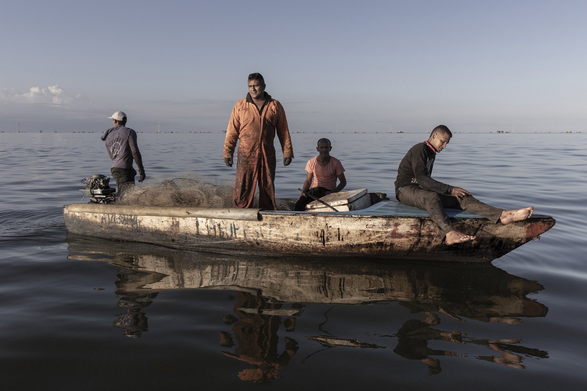 José Lara poses for a portrait on his fishing boat in an oil-soaked Lake Maracaibo, Zulia State, Venezuela. Crude oil and other pollutants spill from badly maintained equipment owned by state oil company PDVSA, which has never fully recovered from strikes in 2002-2003, which ended in the sacking of 18,000 workers.