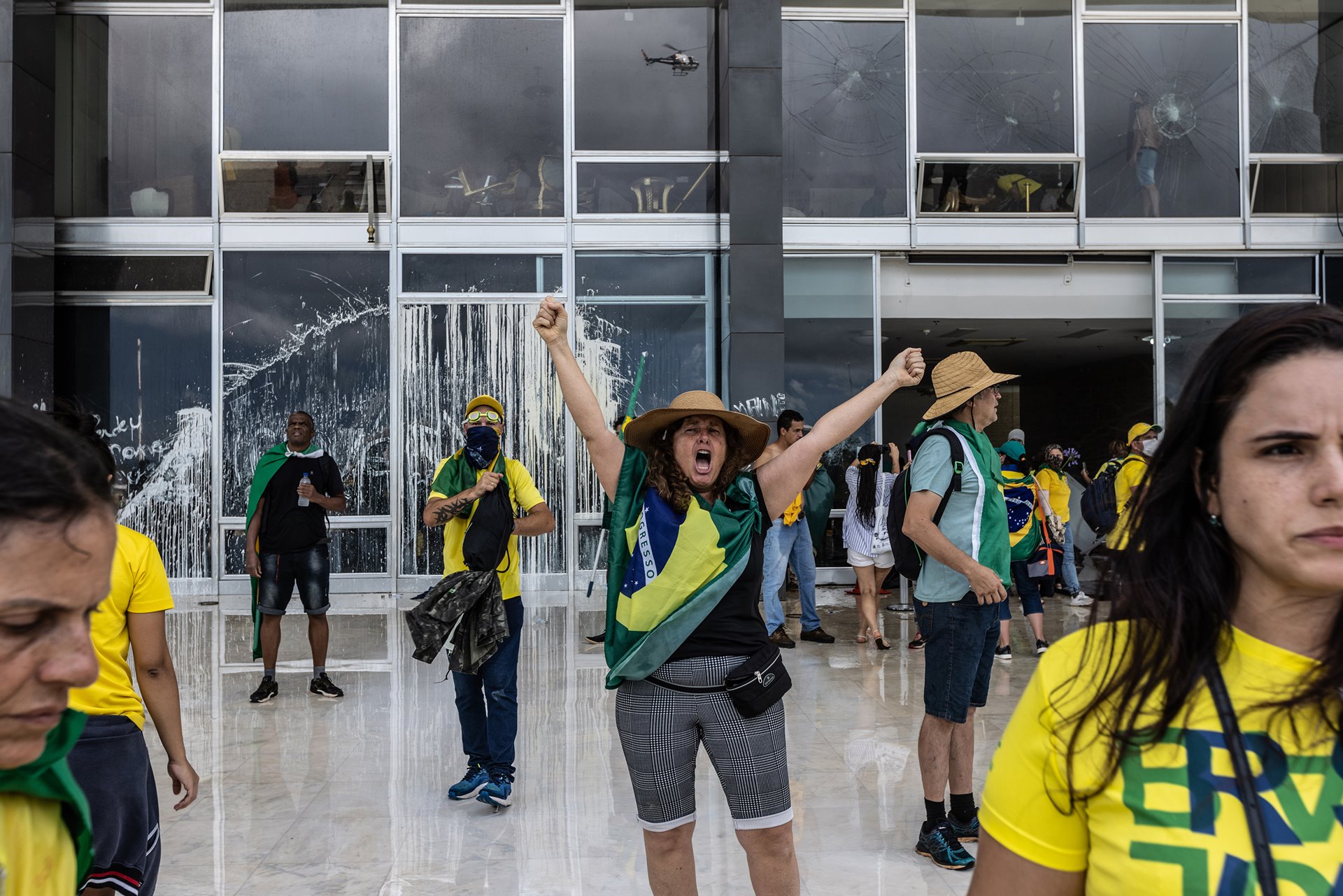 A protestor revels as the Supreme Court is trespassed and vandalized, in Brasília, Brazil.&nbsp;