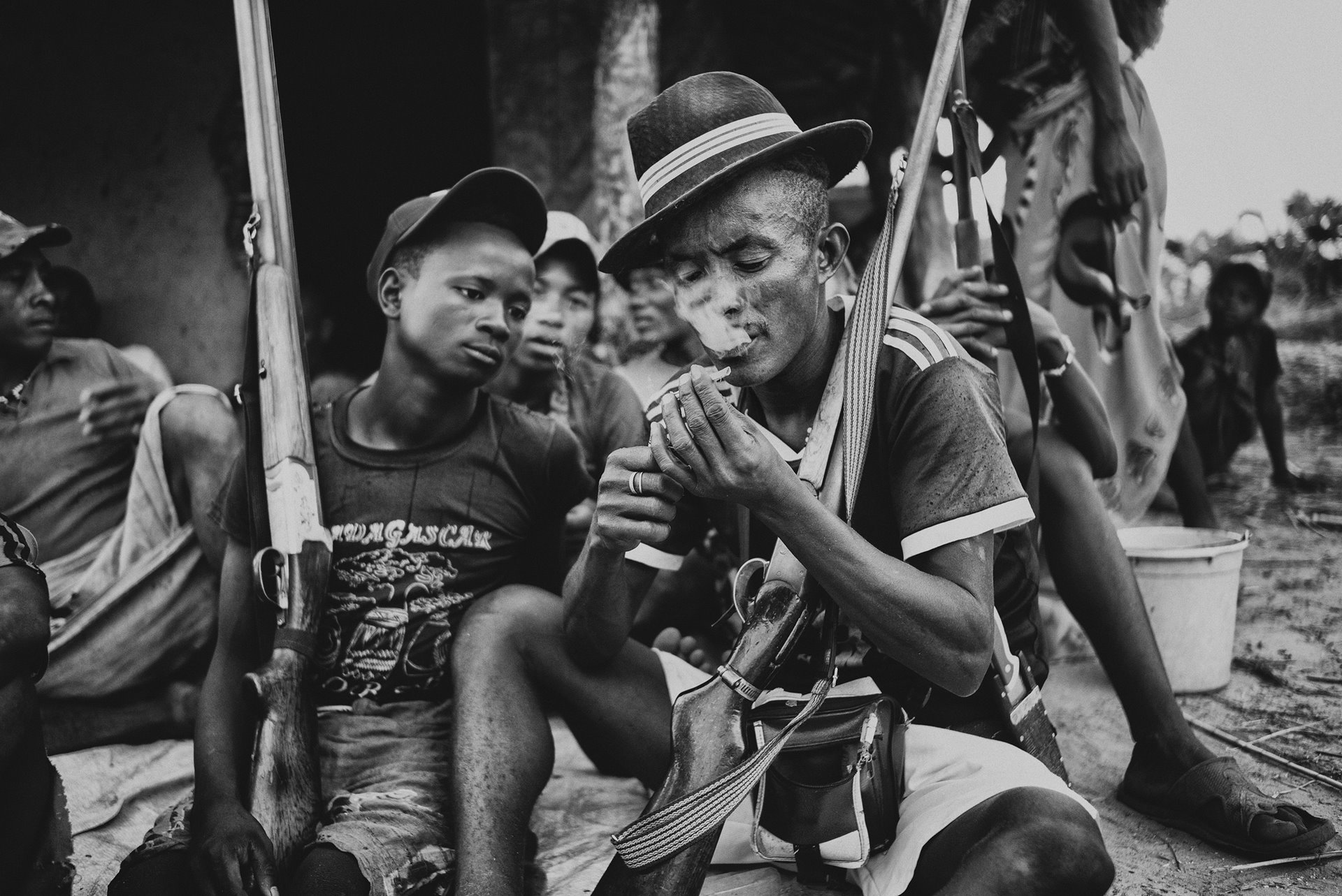 <p>Men smoke local tobacco in the village of Mataviakoho in west-central Madagascar. The village is reputed to be the base of the notorious head of a group of dahalo cattle thieves.</p>
