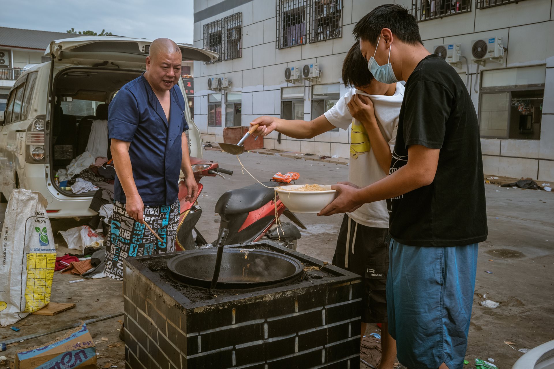 Scam center workers cook food outside a dormitory. Opened in 2024, Shunda Park employed 3,500 people from nearly 30 nations. While some were experienced scammers, many were victims of human trafficking, lured to Myanmar by ads for high-paying tech jobs in Thailand. Min Let Pan, Myanmar