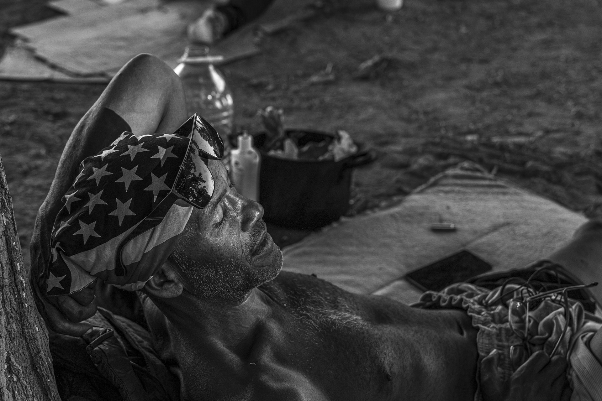 Alexander Gonzalez, a Venezuelan migrant, rests in the 39 degree Celsius heat in Parque Público Federal El Chamizal, in Ciudad Juárez, Mexico. By July 2023, Venezuelan migrants and asylum seekers had the option of trying to enter the United States by crossing the river, facing arrest and deportation, or waiting months for an asylum hearing through the glitchy CBP One app.