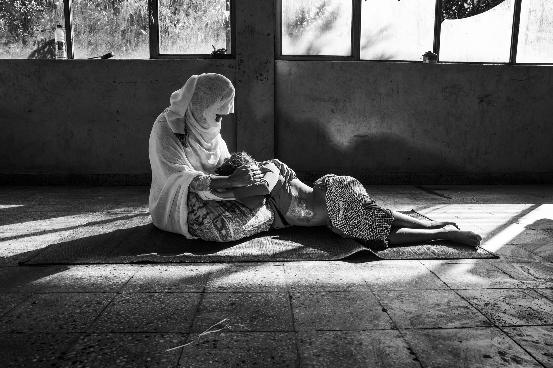Zara (38, not her real name) and her daughter (11), from Tigray, photographed in Adwa, Tigray, Ethiopia. During the war in Tigray, four Eritrean soldiers and one Ethiopian federal government soldier entered their home, raped Zara, and threw a pot of boiling water at her daughter. Zara also suffered from a detached retina from a blow to the head. Without adequate medical assistance, she lost sight in that eye. Access to post-rape medical assistance in Tigray is severely inadequate. It took weeks or even months for several survivors to access services that were often unequipped to meet their needs.