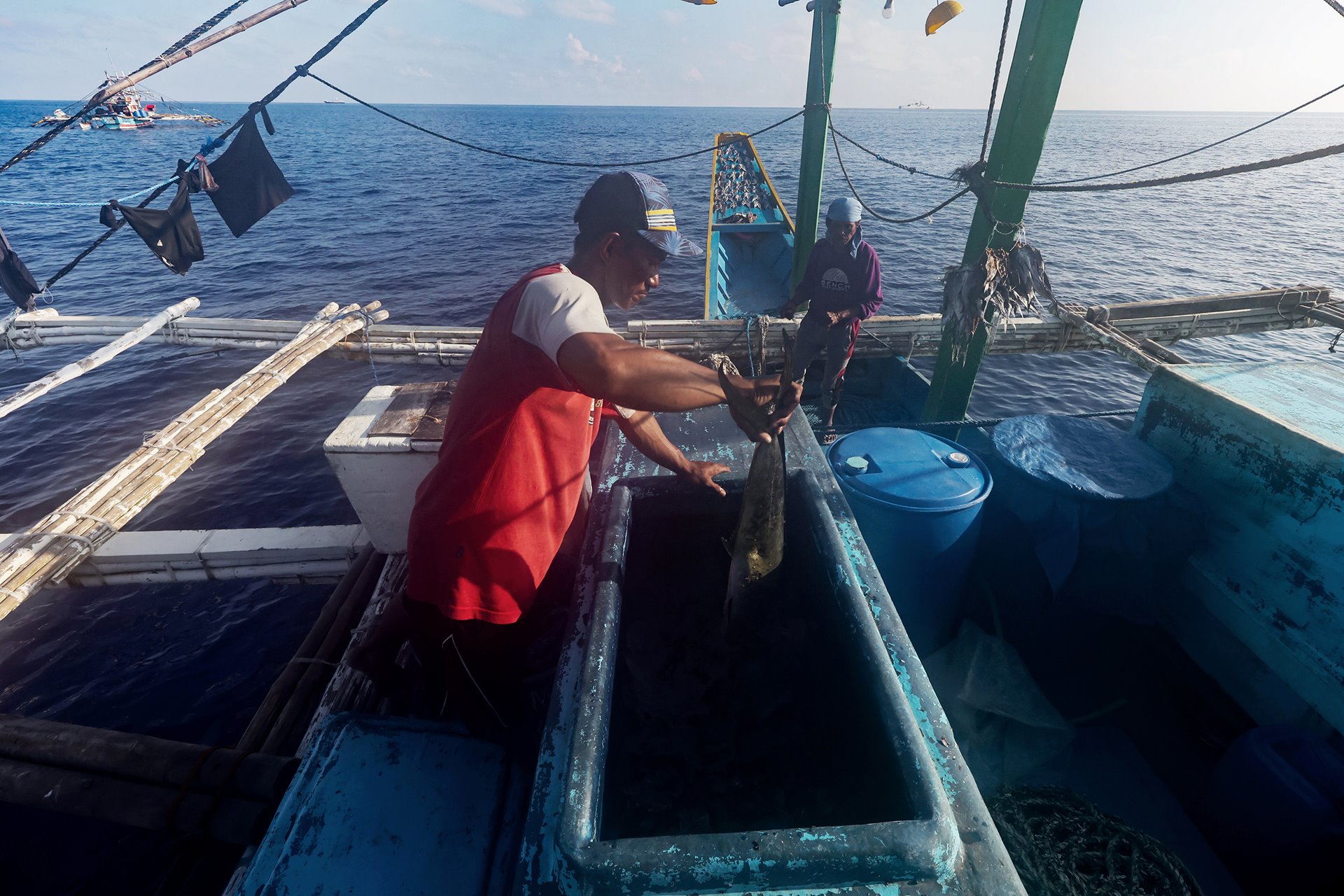 Filipino fishermen check on the catch they have managed outside of the more abundant waters of the Scarborough Shoal lagoon, off Zambales province, Philippines.