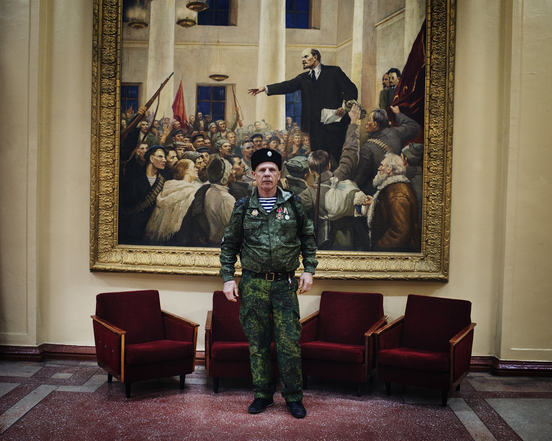 A separatist fighter poses in front of a portrait of Lenin in the arts center at Stakhanov, in territory controlled by forces of the self-proclaimed Luhansk People&rsquo;s Republic (LNR).