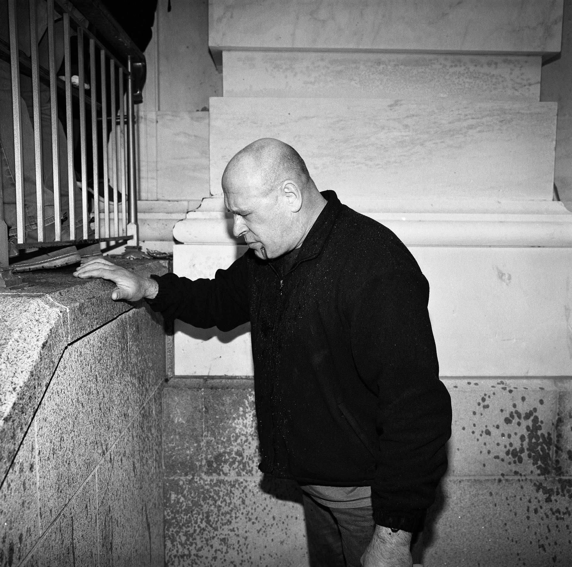 A man bleeding from a face wound and blinded by pepper spray braces himself by one of the doors to the Capitol that was breached by pro-Trump protesters, in Washington DC, USA.