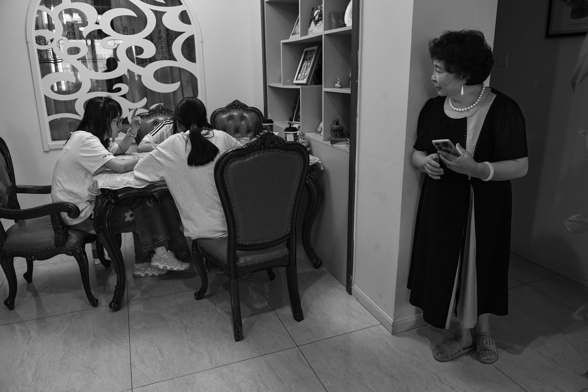 Sheng Hailin oversees a tutoring session at home to help the girls prepare for the high school entrance examination (zhongkao), a critical academic threshold in the Chinese education system. Hefei, Anhui Province, China.&nbsp;