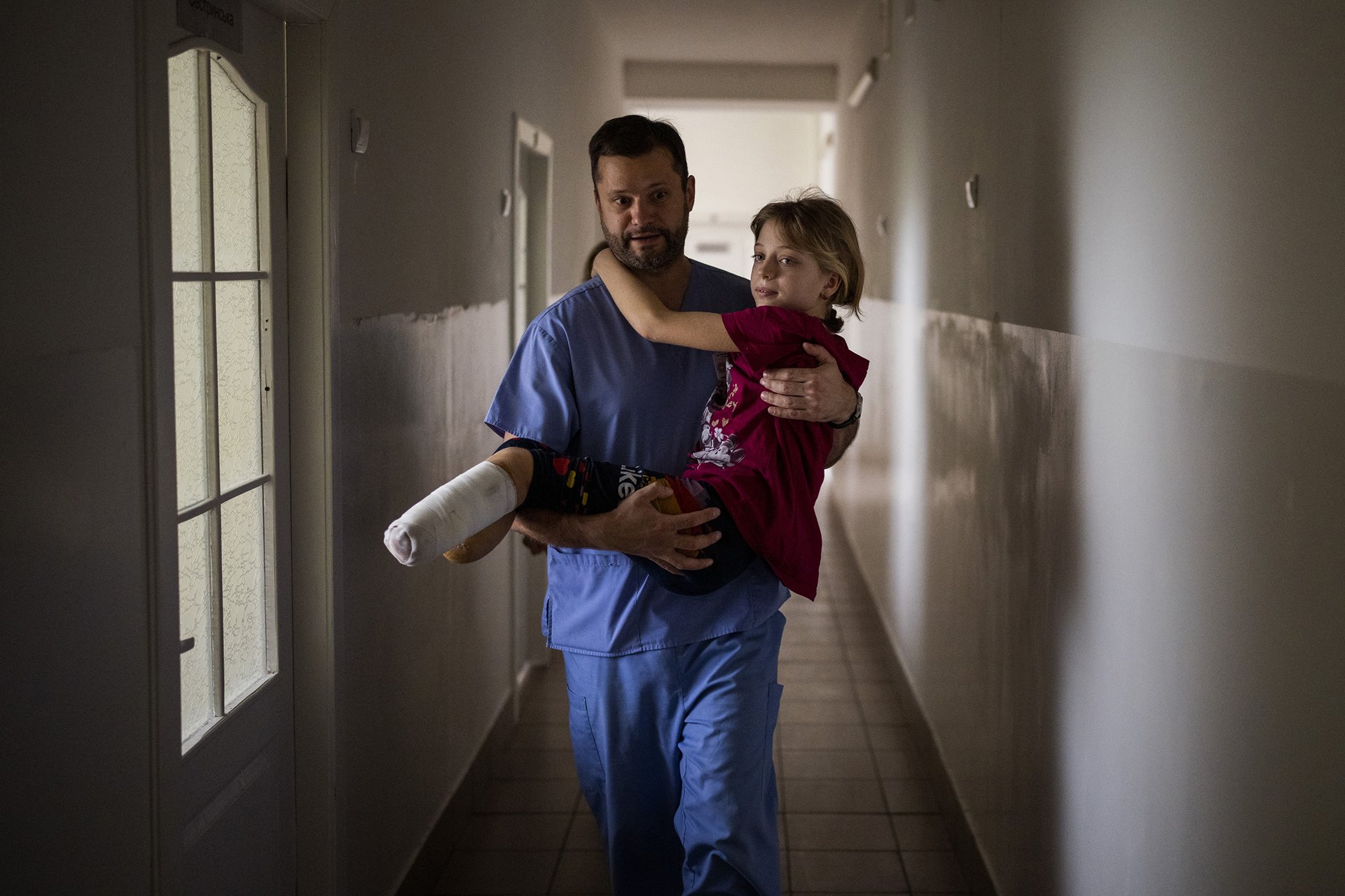 Yana Stepanenko (11) is carried by a doctor at a public hospital in Lviv, Ukraine. Yana, her mother Natasha (43), and her twin brother Yarik (11) were injured during shelling of a train station in the eastern city of Kramatorsk, on 8 April. According to the UN Human Rights Office, some 60 civilians were killed, and 110 wounded in a Russian missile strike on the station. Thousands of civilians were gathered there, awaiting evacuation. Russia denied involvement, claiming the strike was orchestrated by Ukraine. The family were later flown to San Diego, in the United States, where Yana and Natasha received new prostheses, and Yana underwent surgery.