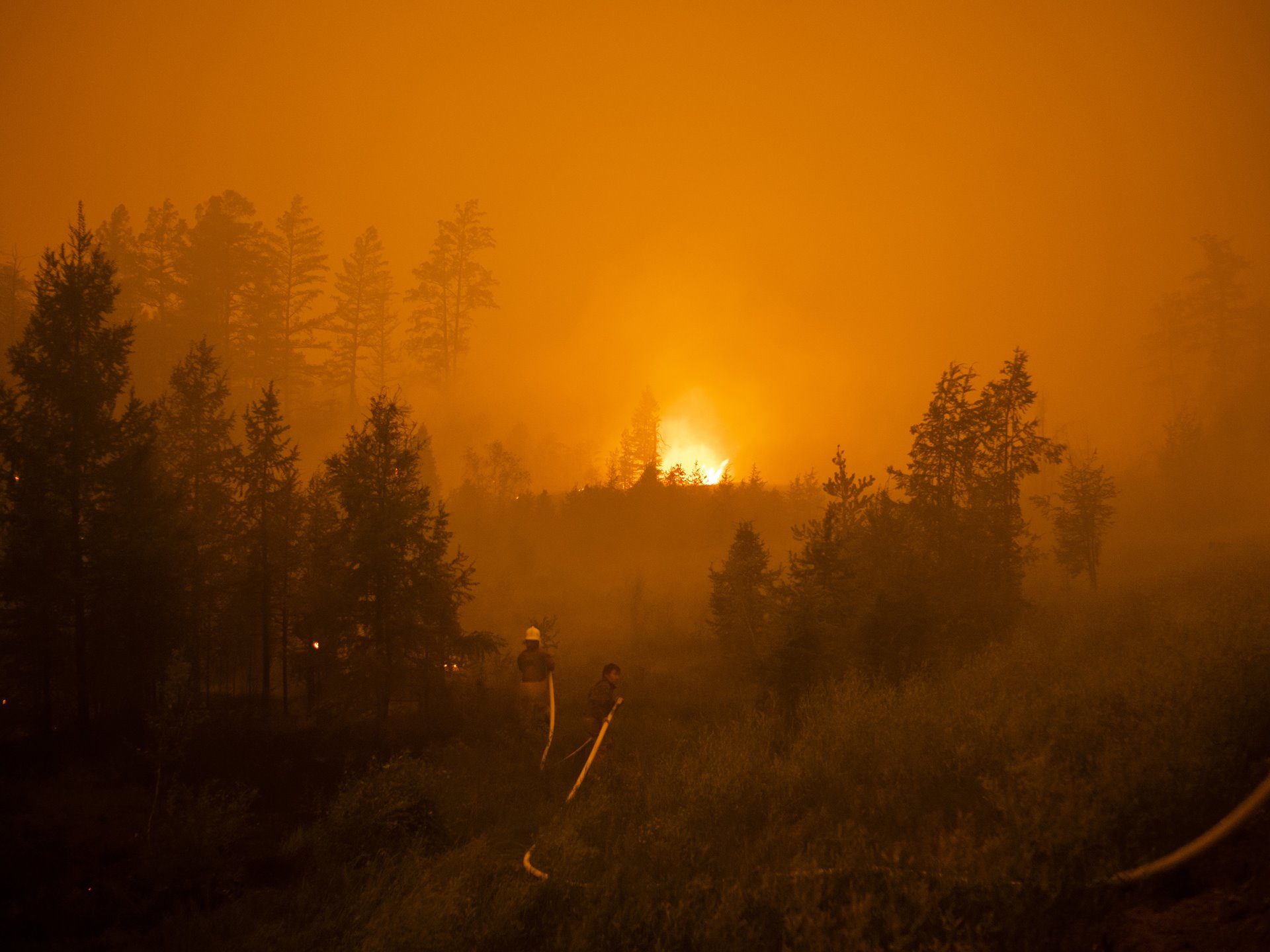 A forest fire burns beside the road between Magaras and Berdigestyakh, in central Sakha, Siberia, Russia.