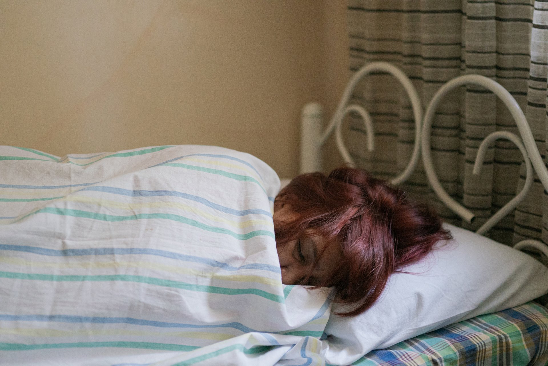 Nanette Castillo sleeps in during a grief counseling retreat in Bulacan, the Philippines. Her son Aldrin was killed in 2017 by unidentified gunmen, a few yards away from a police station.