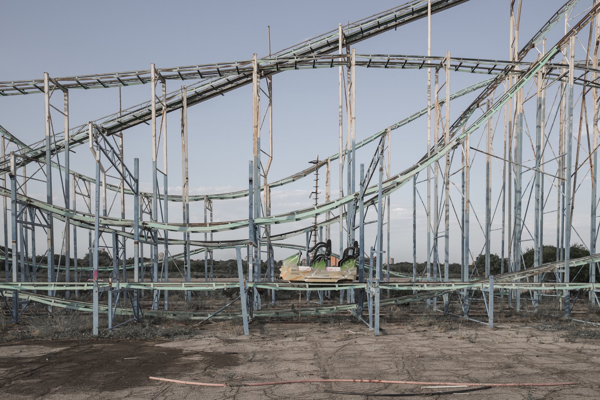 A roller coaster lies abandoned at the derelict Grano de Oro theme park in Maracaibo, Zulia State, Venezuela. Maracaibo was once one of the richest cities in Venezuela, deriving wealth from its oil facilities. However, by 2021, 49.6% of households in Zulia had a monthly income of just US$11-US$50, according to local human rights organization CODHEZ.