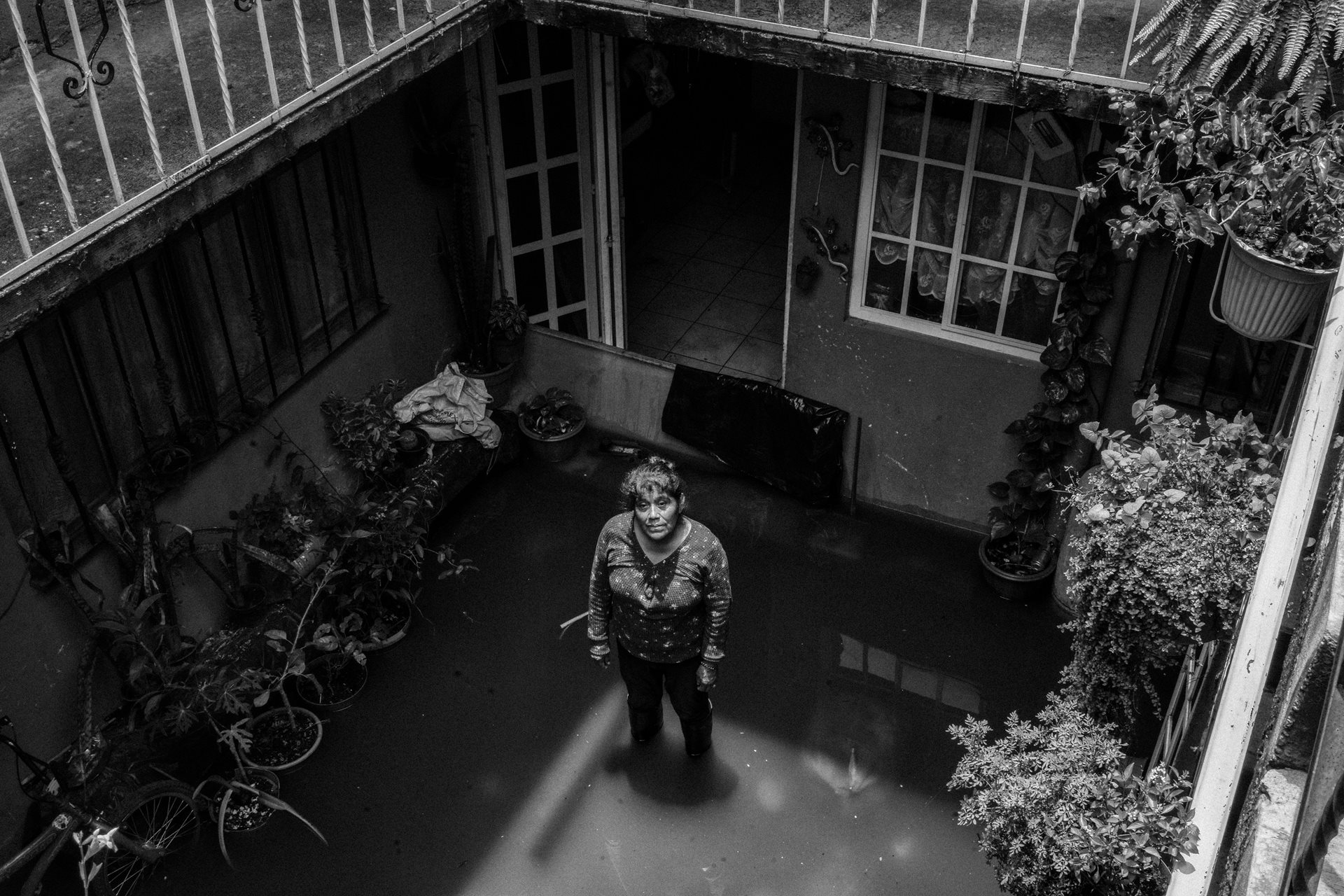 <p>A woman stands in her flooded patio in Chalco. Sewage-infused floodwaters submerged over 2,000 homes for 40 days in 2024. State of Mexico, Mexico<br />
<br />
&nbsp;</p>
