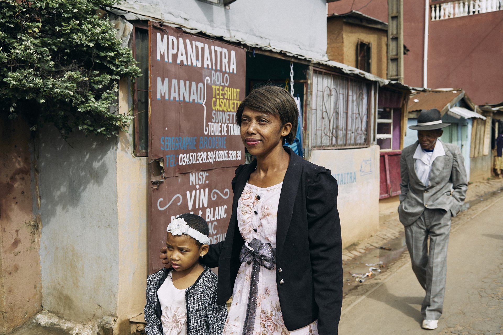 Fara Rafaraniriana walks to church on Sunday morning with her daughter Odliatemix and her father Dada Paul, in Antananarivo, Madagascar.