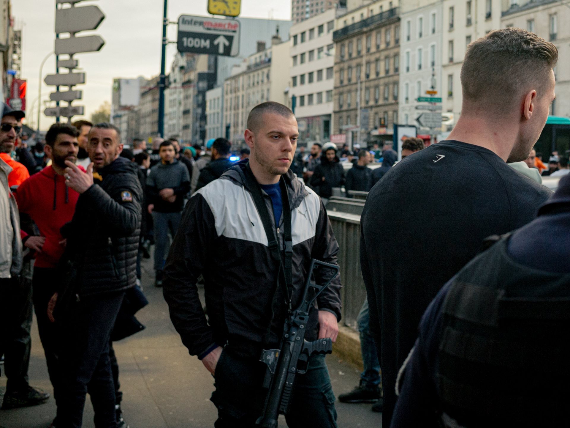 A plainclothes officer of the anti-crime brigade (BAC) patrols the street near Aubervilliers-Pantin Quatre Chemins station in Pantin, France, following the arrest of individuals involved in a violent altercation in the basement of a nearby bakery.