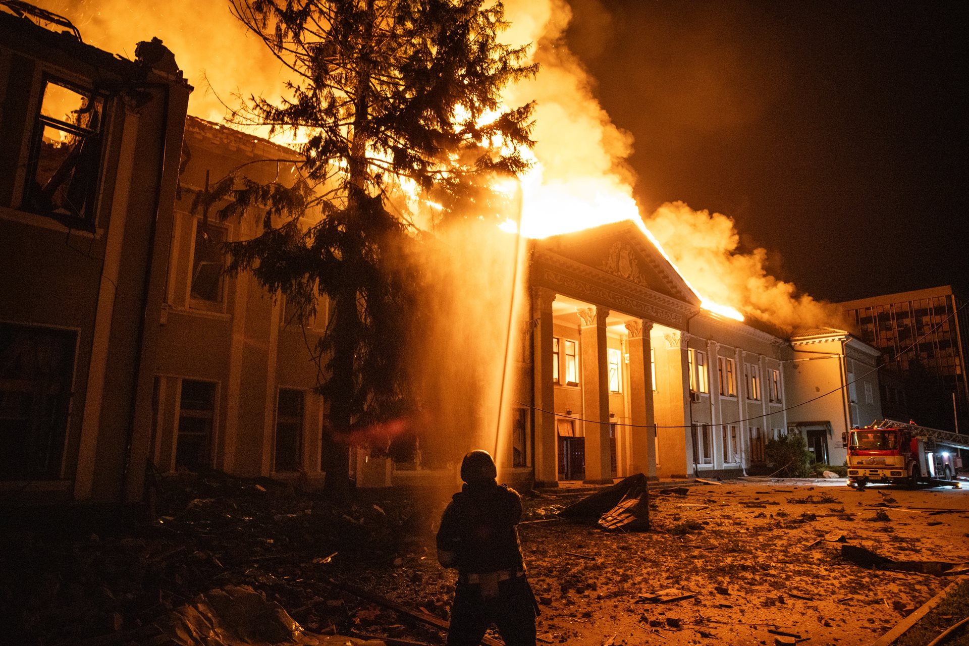 Ukrainian firefighters battle a blazing building in central Kharkiv, after several Russian Shahed-style long range drones struck the area around midnight.