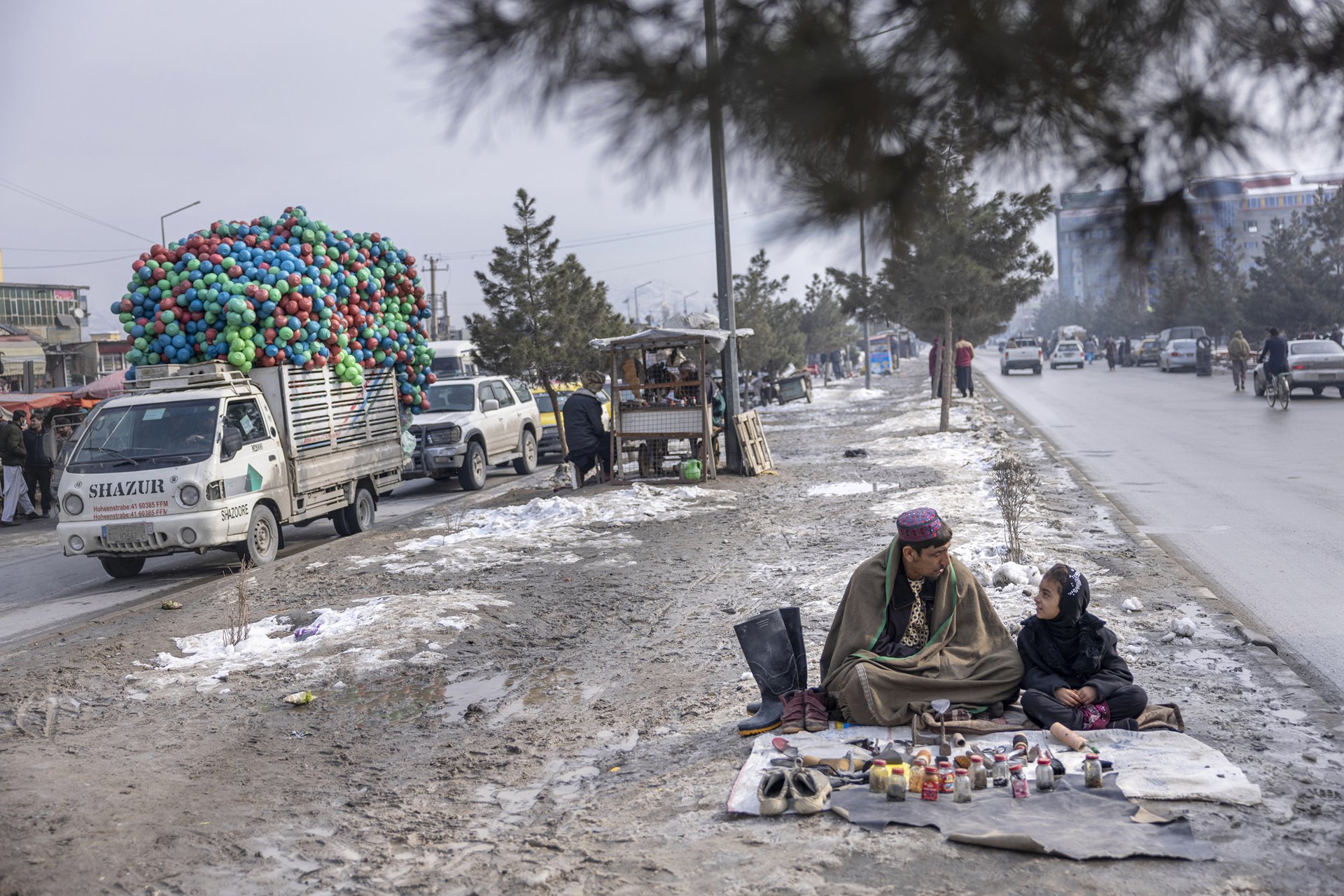 Pacha and his daughter, Bebe Aisa, clean and polish shoes to make enough money for food in the streets of Kabul, Afghanistan. Shoe repair costs 5 Afghani (approximately US$0.05); a loaf of bread costs 10 Afghan, but fewer and fewer people can afford Pacha&rsquo;s services.&nbsp;