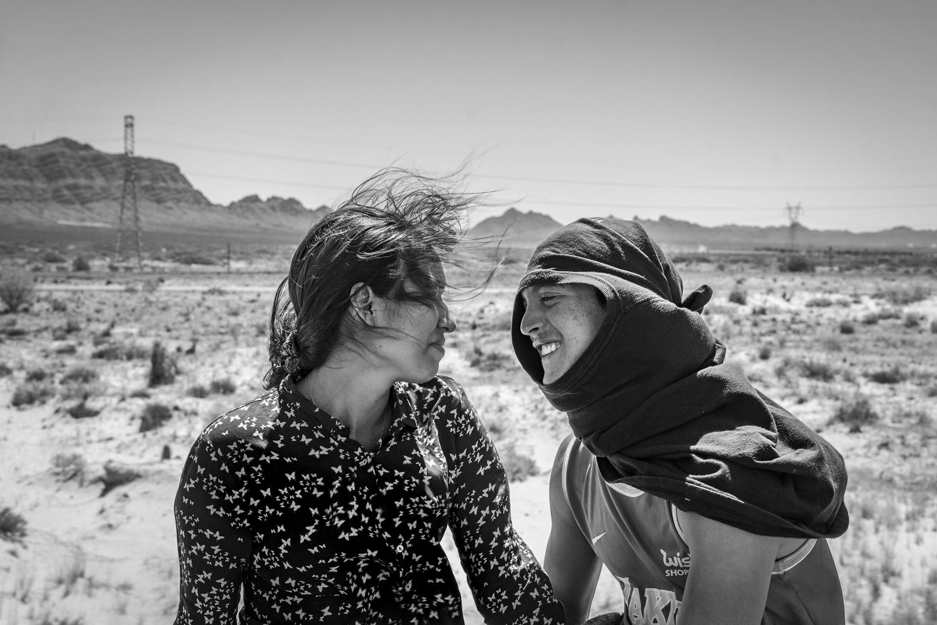 Ruben Soto (right), a migrant from Venezuela, sits with Rosa Bello, a Honduran migrant, atop a freight train known as &ldquo;The Beast,&rdquo; in Samalayuca, Mexico. Ruben and Rosa met in Mexico and fell in love on their way to the United States.&nbsp;