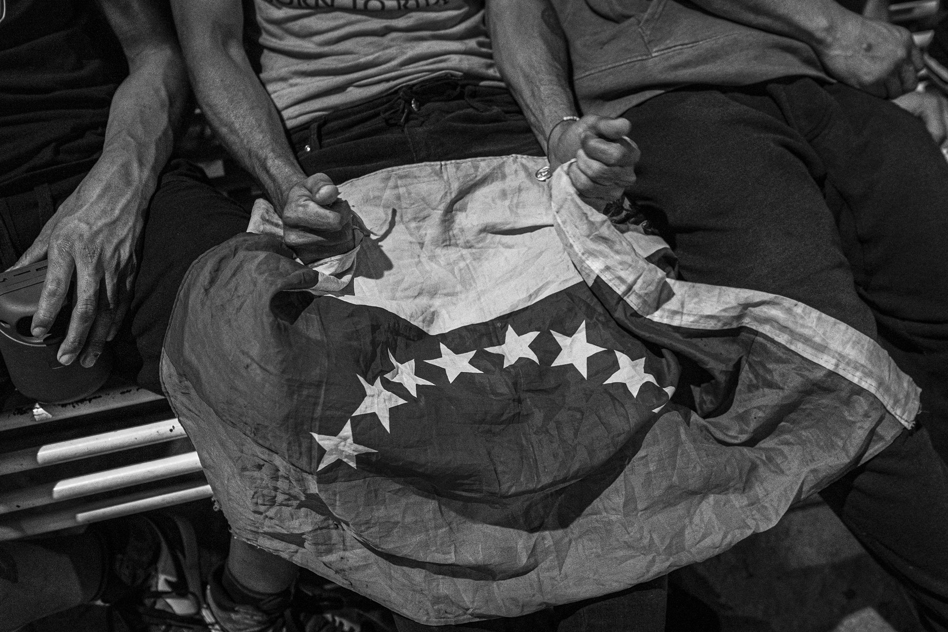 A Venezuelan migrant holds the flag of Venezuela before departing in a migrant caravan, the first one ever consisting mostly of Venezuelans. Tapachula, Mexico.&nbsp;