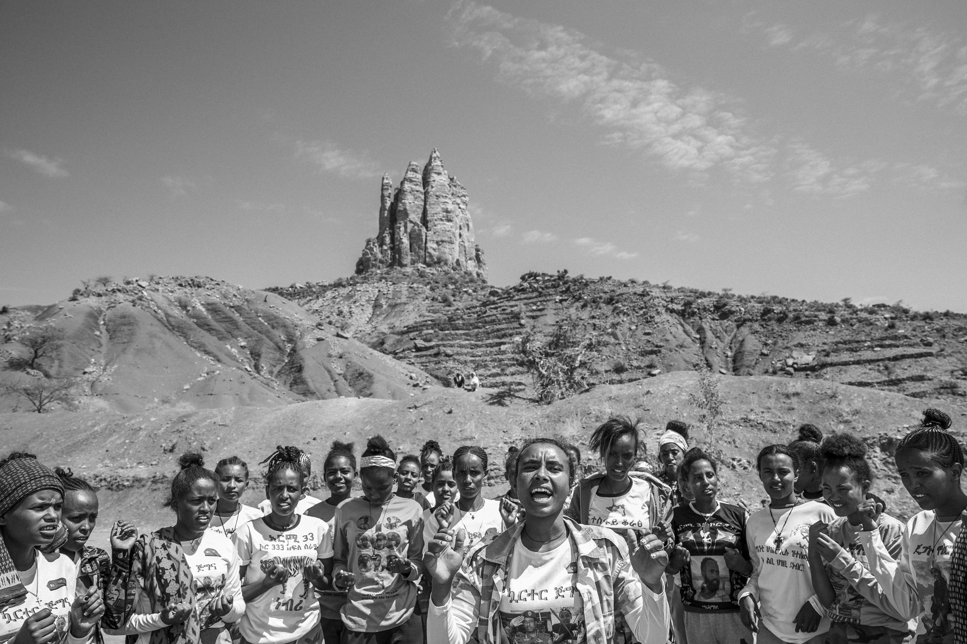 Marhawit (21, center) leads a group of female soldiers in a cheer, in Neblet, Tigray, Ethiopia. Many are minors who joined the Tigrayan army for safety. Leaders like Marhawit provide emotional support and a sense of unity and purpose.