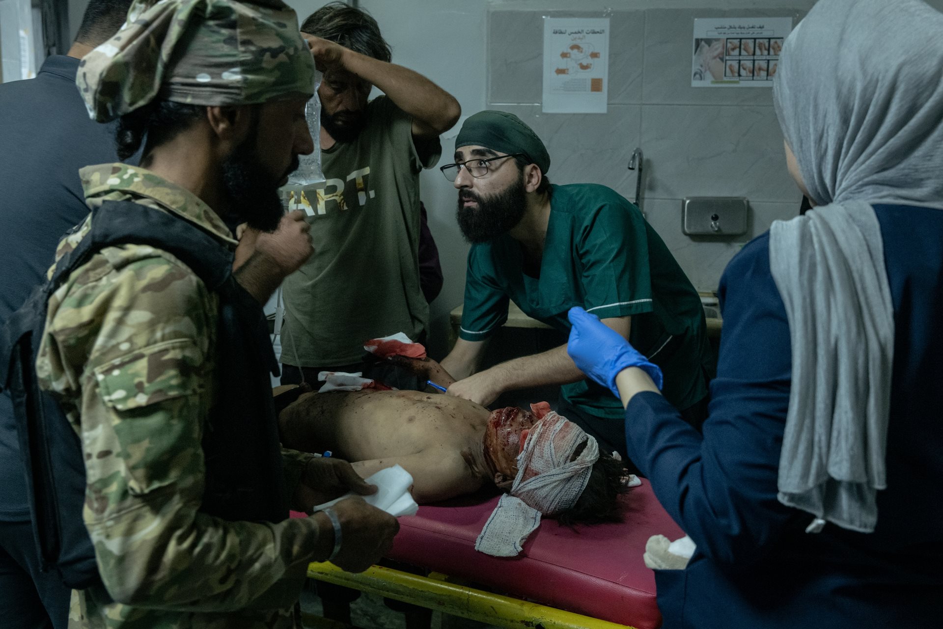 Fadi (13) receives treatment for his injuries at the National Hospital&nbsp;in Deir al-Zour, Syria. The boy was injured and his mother was killed as they scavenged for scrap plastic at a dump site, accidentally detonating an unexploded device.