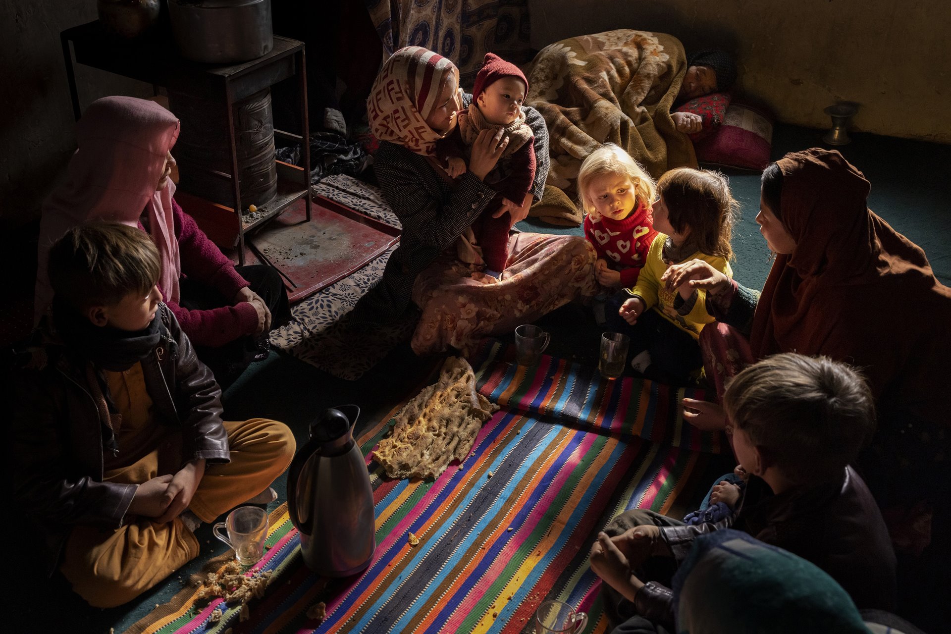 Lunch at the home of Nafisa (25) who is surrounded by her family members weakened by the food crisis. Her son, Hojatullah (11 months old), is severely malnourished. &ldquo;The nurses thought he was too quiet, he did not try to crawl, and when he was measured and weighed, they said he was severely malnourished. I breastfeed him, but I do not get enough to eat myself, so the milk is not worth much&rdquo;, explains Nafisa. Alibeg, Afghanistan.