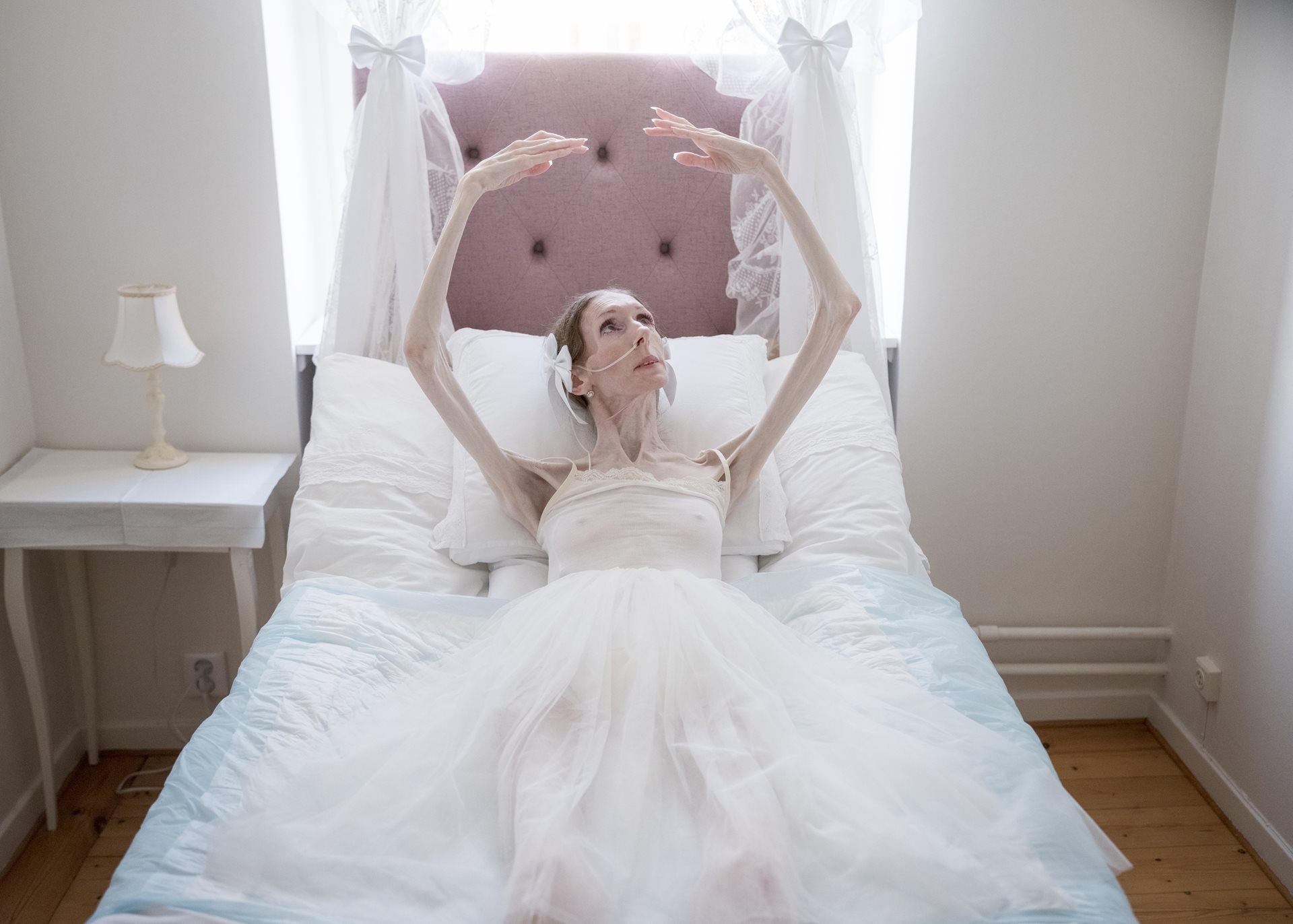 <p>Engla Louise&rsquo;s &ldquo;bed ballet&rdquo; &ndash; movements performed lying down &ndash; keeps her connection to dance alive. Every day at a specific time, she watches ballet on her iPad. Linköping, Sweden.</p>
<br />
&nbsp;