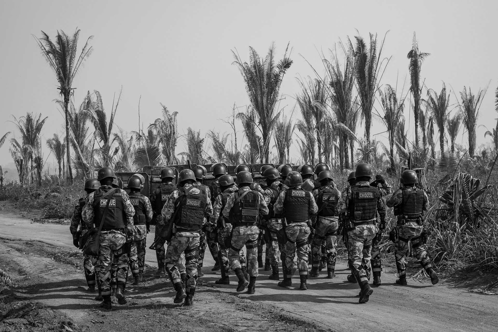 Riot police walk down a road inside the Bom Futuro National Forest, in Rondônia, in the Brazilian Amazon, to remove invaders who had set up a camp with about 200 shacks inside the reserve. Such camps are usually set up for purposes such as illegal logging. In 2019, Bom Futuro lost 874 hectares of forest, according to &nbsp;the National Institute for Space Research (INPE). This represented the largest loss of vegetation cover in the conservation area in 12 years. Deforestation of the reserve increased to 1,135 hectares the following year.