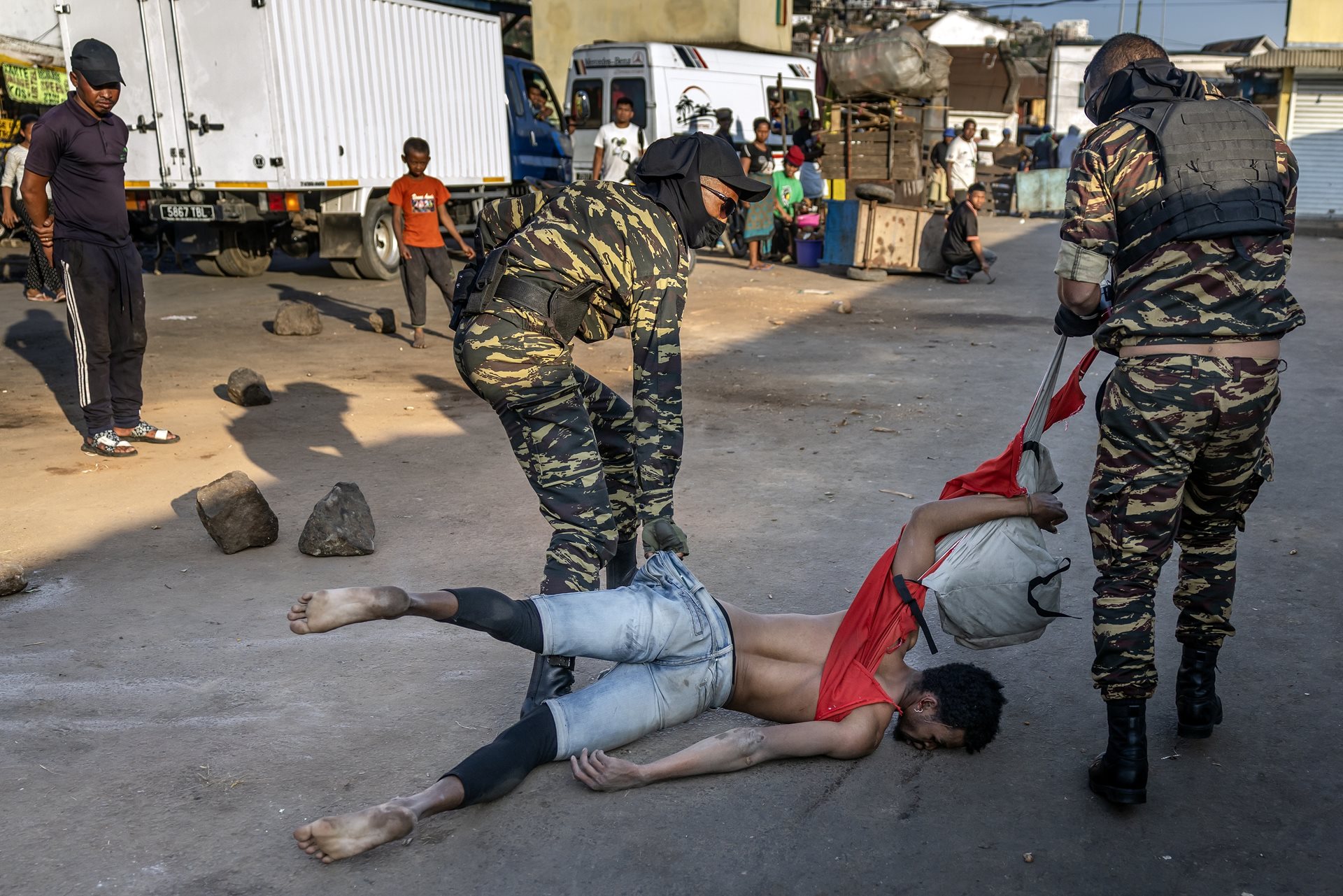 Members of the Malagasy Gendarmerie drag a severely beaten protester during clashes that killed at least 22 people and injured more than 100 others. Antananarivo, Madagascar.