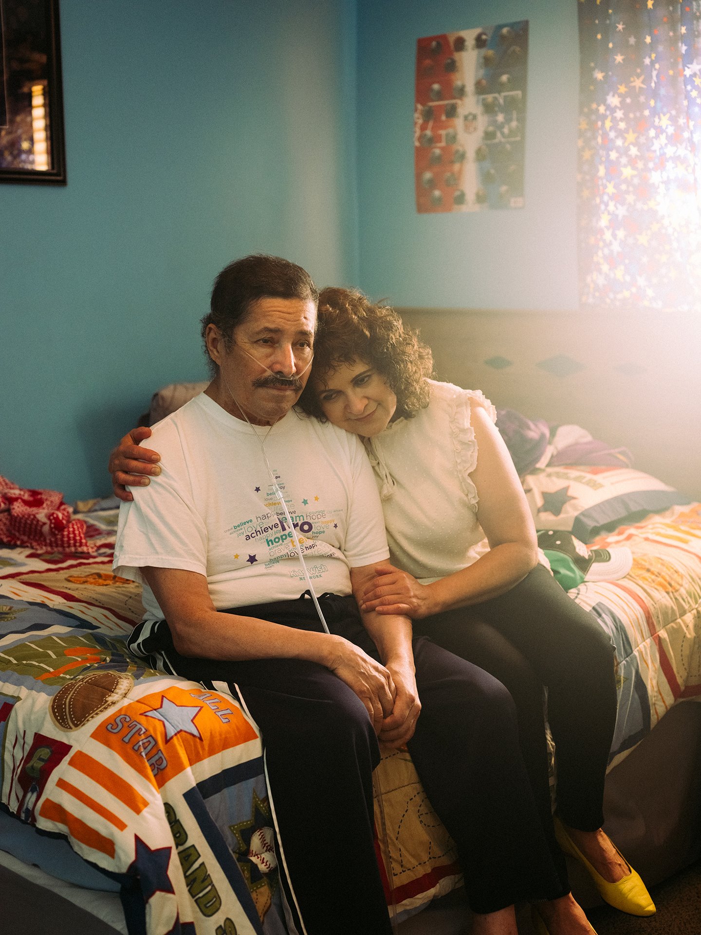 José sits in his room with his sister Sara, in Sioux Falls, South Dakota, USA. José worked in a meatpacking plant until contracting COVID-19 in April 2020. He was in hospital on a ventilator for five months, and still uses an oxygen cylinder. Sara also worked at the factory, but left to become a house cleaner. She took care of her brother during his illness.&nbsp;