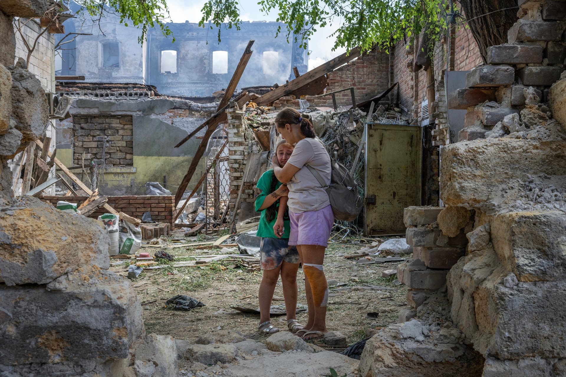 Natalia Harbuznia comforts her daughter Victoria after a swarm of Russian long-range drones attacked their neighborhood in Odesa, Ukraine, injuring at least 11 people including Natalia.&nbsp;