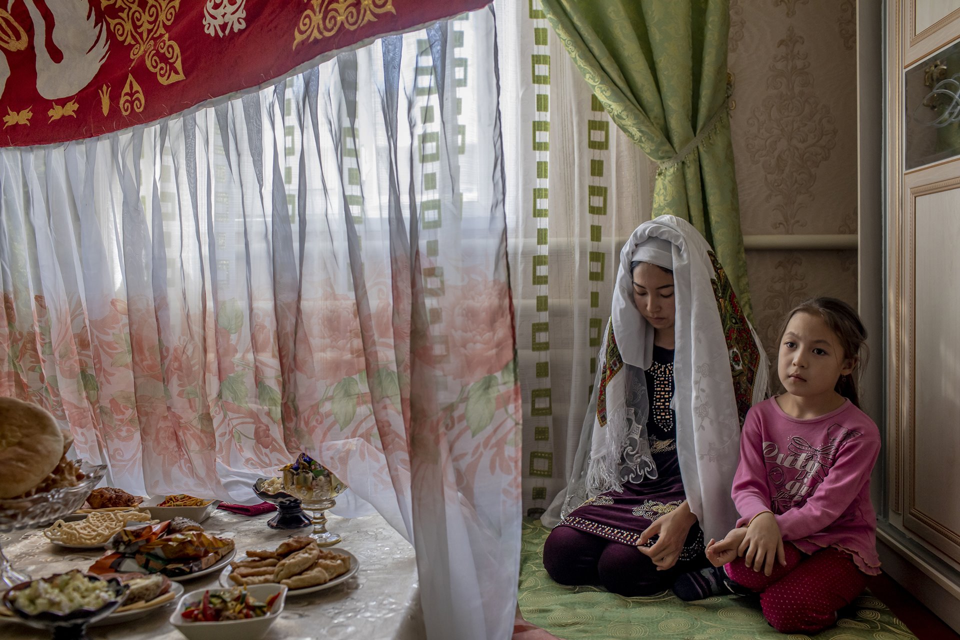 Dinara (18) sits with a relative on her wedding day in Muynak, Uzbekistan. Once a port on the Aral Sea, Muynak is now more than 150 kilometers from the coast. Dinara&rsquo;s father and new husband travel there to work farming minute <em>Artemia salina</em> brine shrimps. Her grandparents also worked in the fishing industry, when Muynak was still on the water&rsquo;s edge.&nbsp;