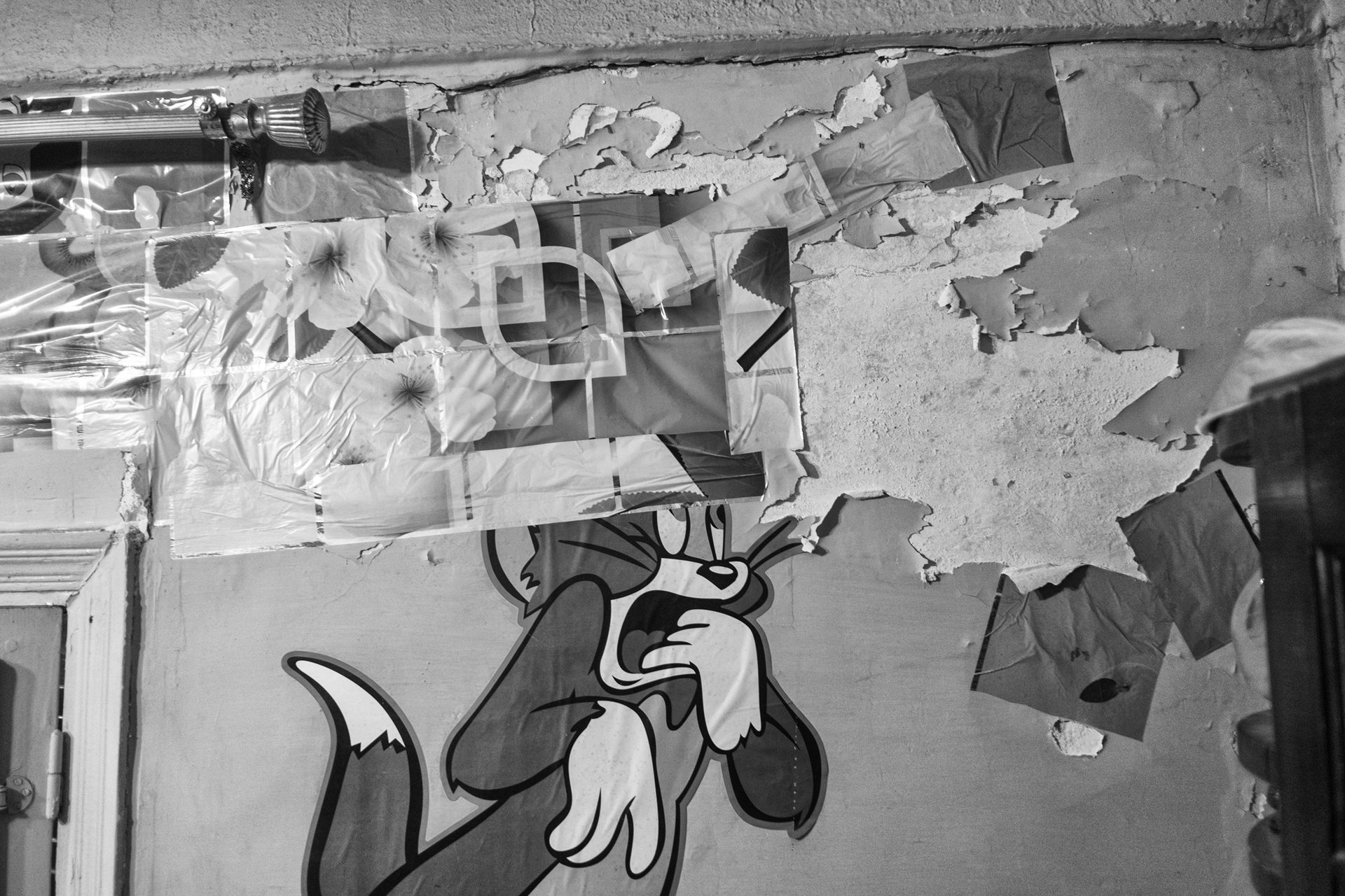 Vibrations from the Titan cement factory damage the walls of nearby houses and cause roofs to give way. Ola, who lives directly opposite, patches cracks with stickers and tape. Moon Valley, Alexandria, Egypt.&nbsp;