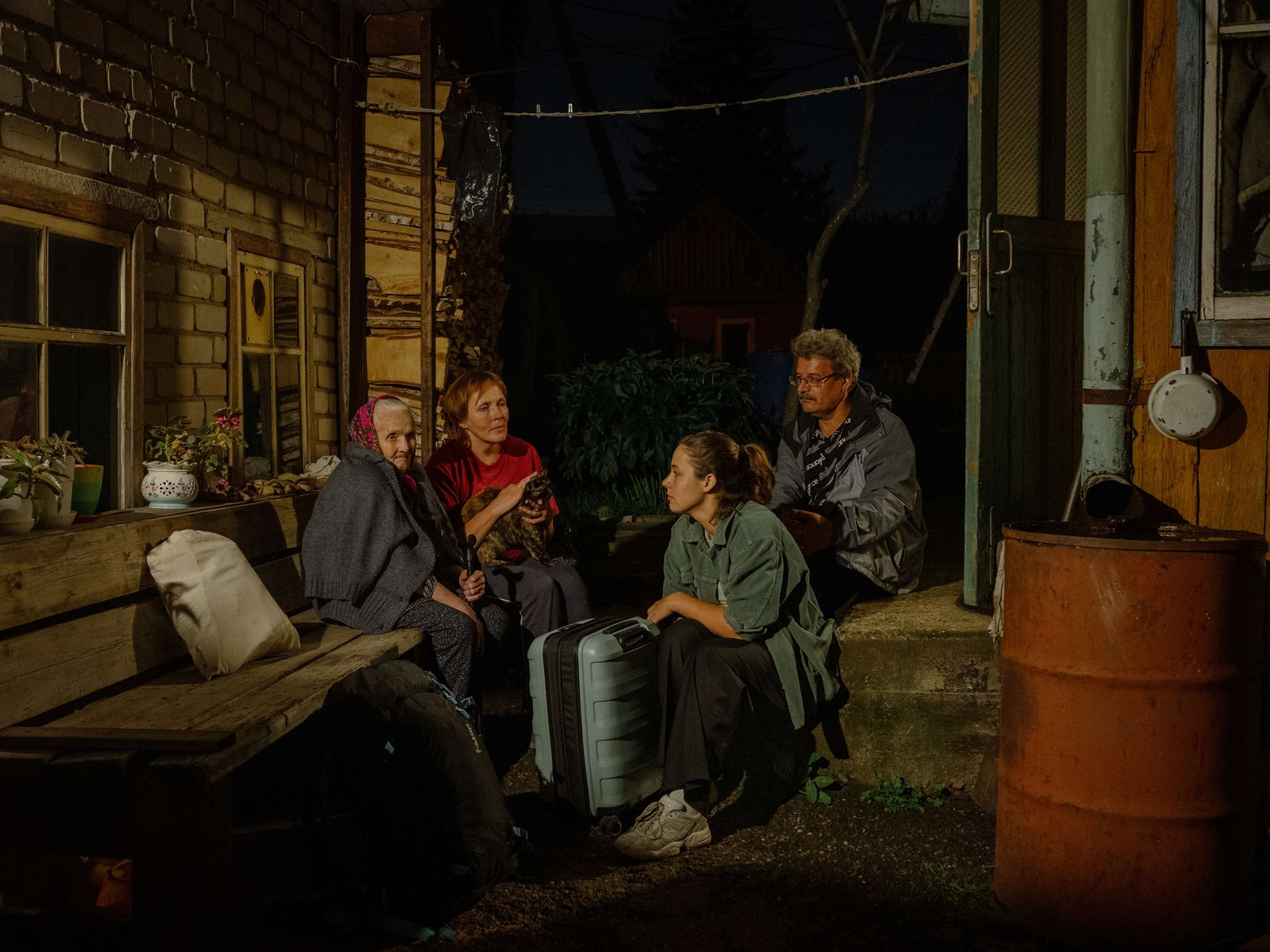 Aliona, her parents, and grandmother sit on the porch of the family home in Tomsk, Russia, before her return to Germany. She says: &ldquo;I love this Russian tradition of &lsquo;sitting on the road&rsquo;. You all sit down together for a minute to think about what you leave behind.&rdquo;&nbsp;