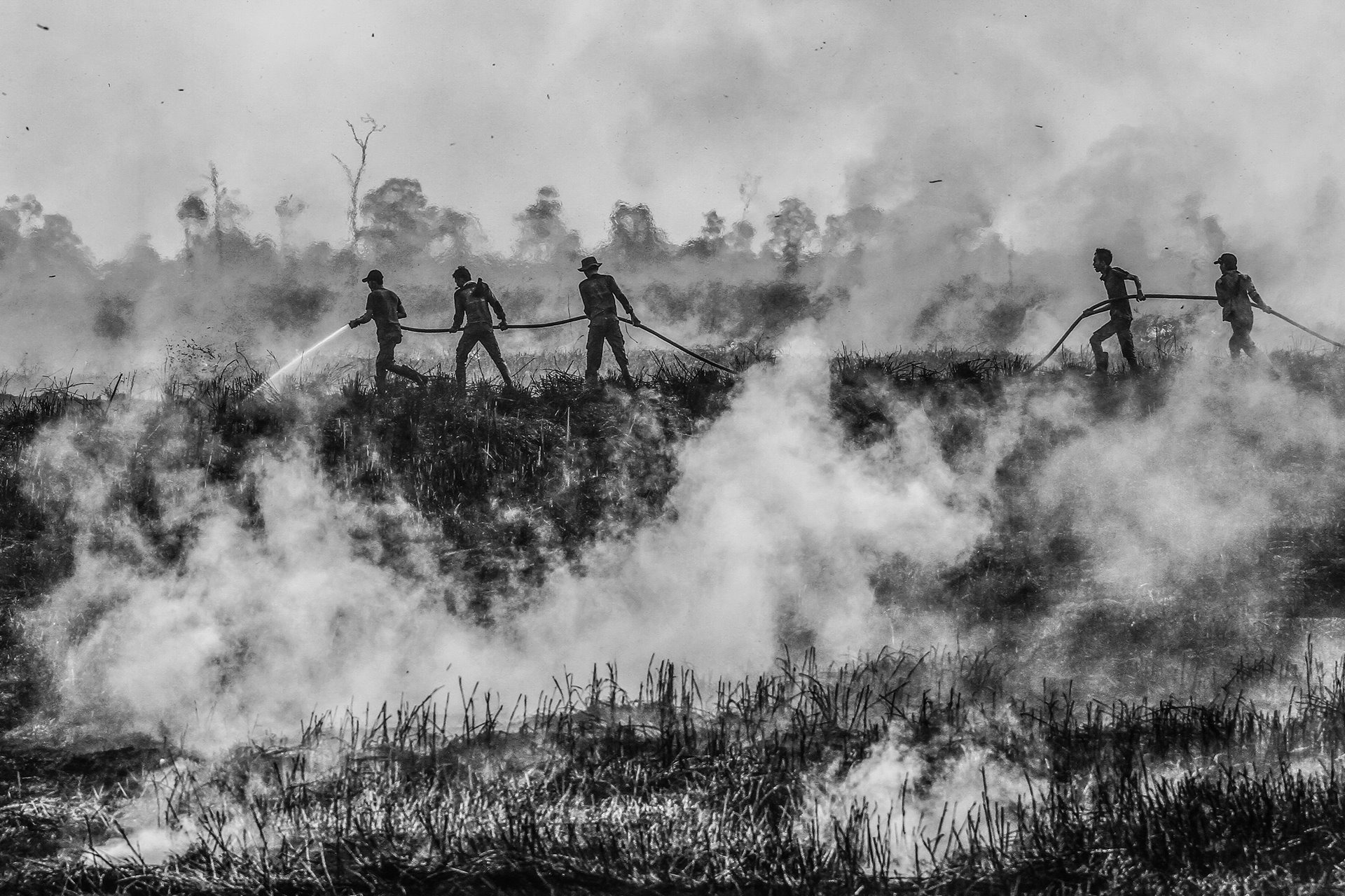 <p>Firefighters battle a fire in Ogan Ilir, South Sumatra. The World Bank estimated that the 2015 fires crisis cost Indonesia US$16 billion in losses to forestry, agriculture, tourism and other industries.</p>
