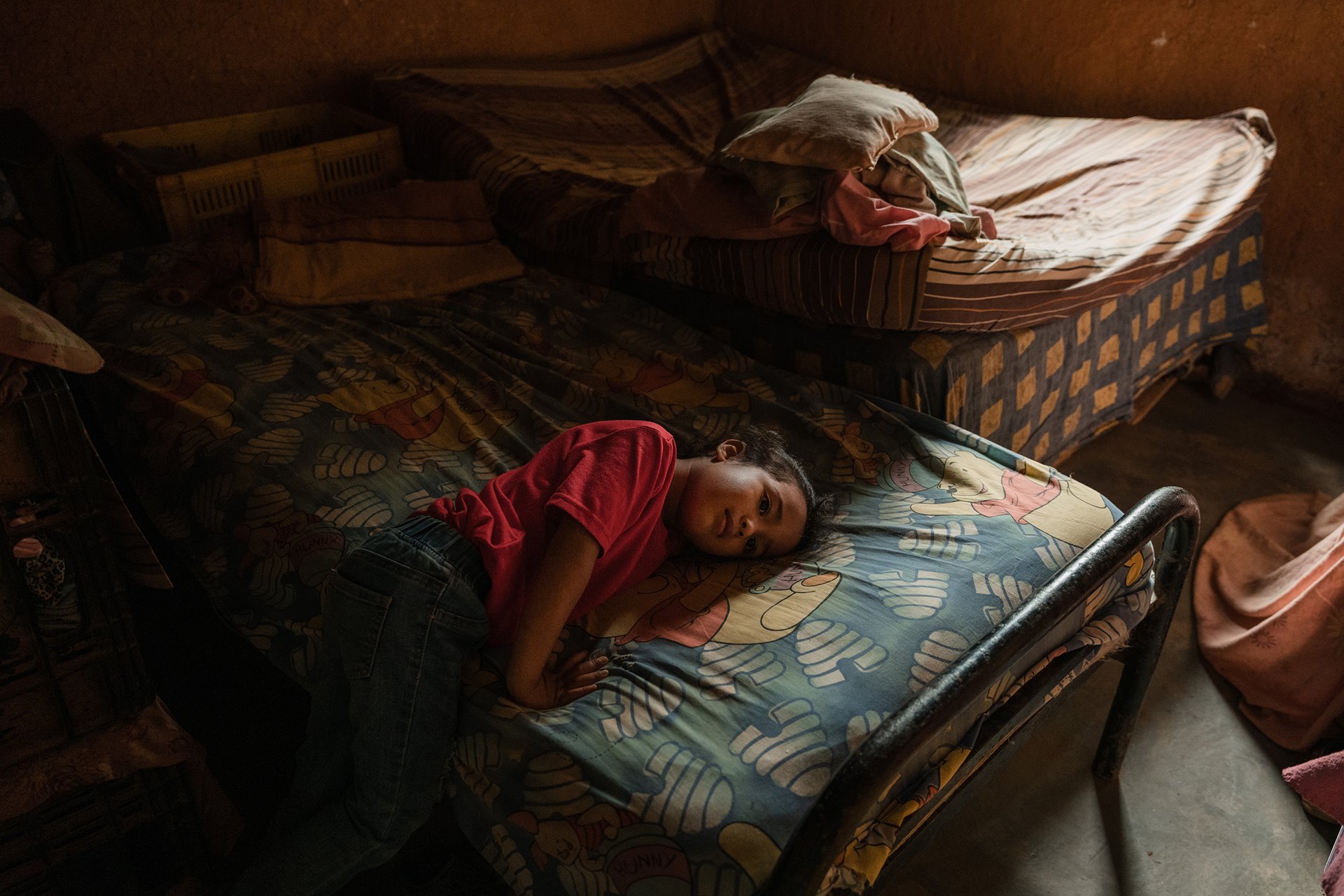 Clarelys Lopez-Jimenez (4) rests in the room she shares with her family of four, in San Diego de Los Altos, Venezuela. Her mother is a kindergarten teacher, whose US$6 monthly salary barely covers her basic needs. She plants beans and avocados to barter with her neighbors.&nbsp;<br />
&nbsp;