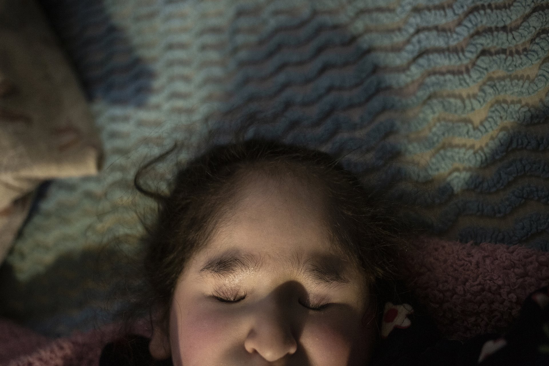 <p>Carmelita (16) lies on her bed, in Villa Guerrero, Mexico. Photosensitivity caused by encephalomalacia (softening of the brain tissue) gives Carmelita such pain that she cannot go out into the light.</p>
