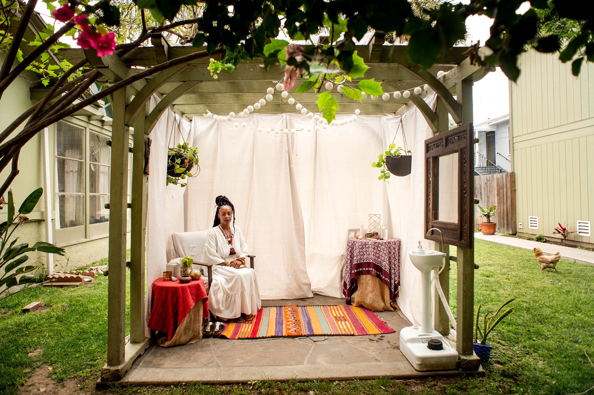 Midwife Racha Tahani Lawler sits in the space in her garden where she meets with clients, in Los Angeles County, USA. Lawler once owned a community birth center, but without medical insurance covering midwifery found it to be difficult to sustain and now assists at home births.